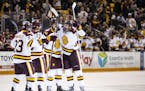 UMD forward Noah Cates (21) celebrated with his teammates after scoring the game tying goal with 31 seconds remaining in the third period.