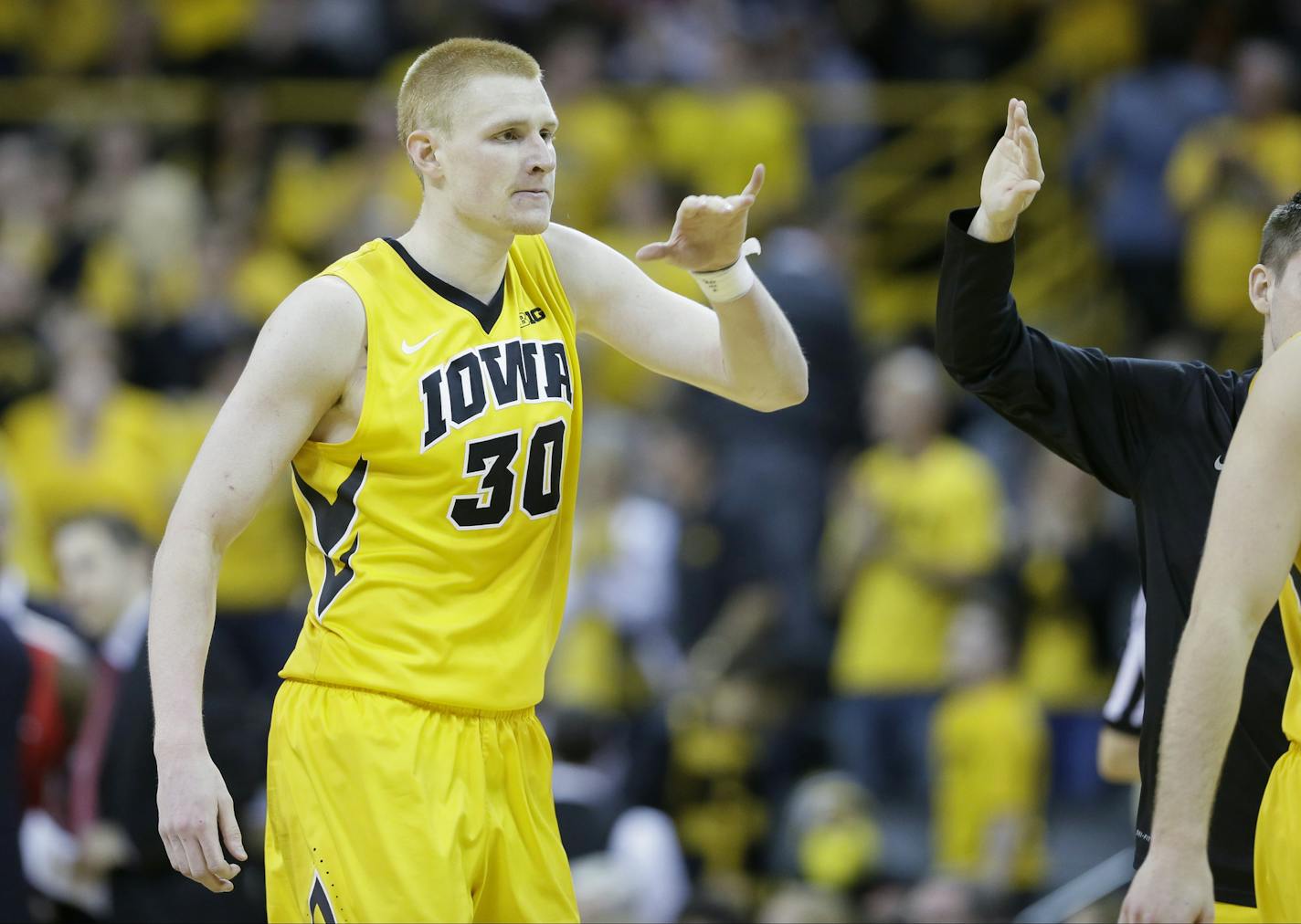 Iowa forward Aaron White reacts with teammates during the second half of an NCAA college basketball game against Ohio State, Saturday, Jan. 17, 2015, in Iowa City, Iowa. Iowa won 76-67. (AP Photo/Charlie Neibergall)