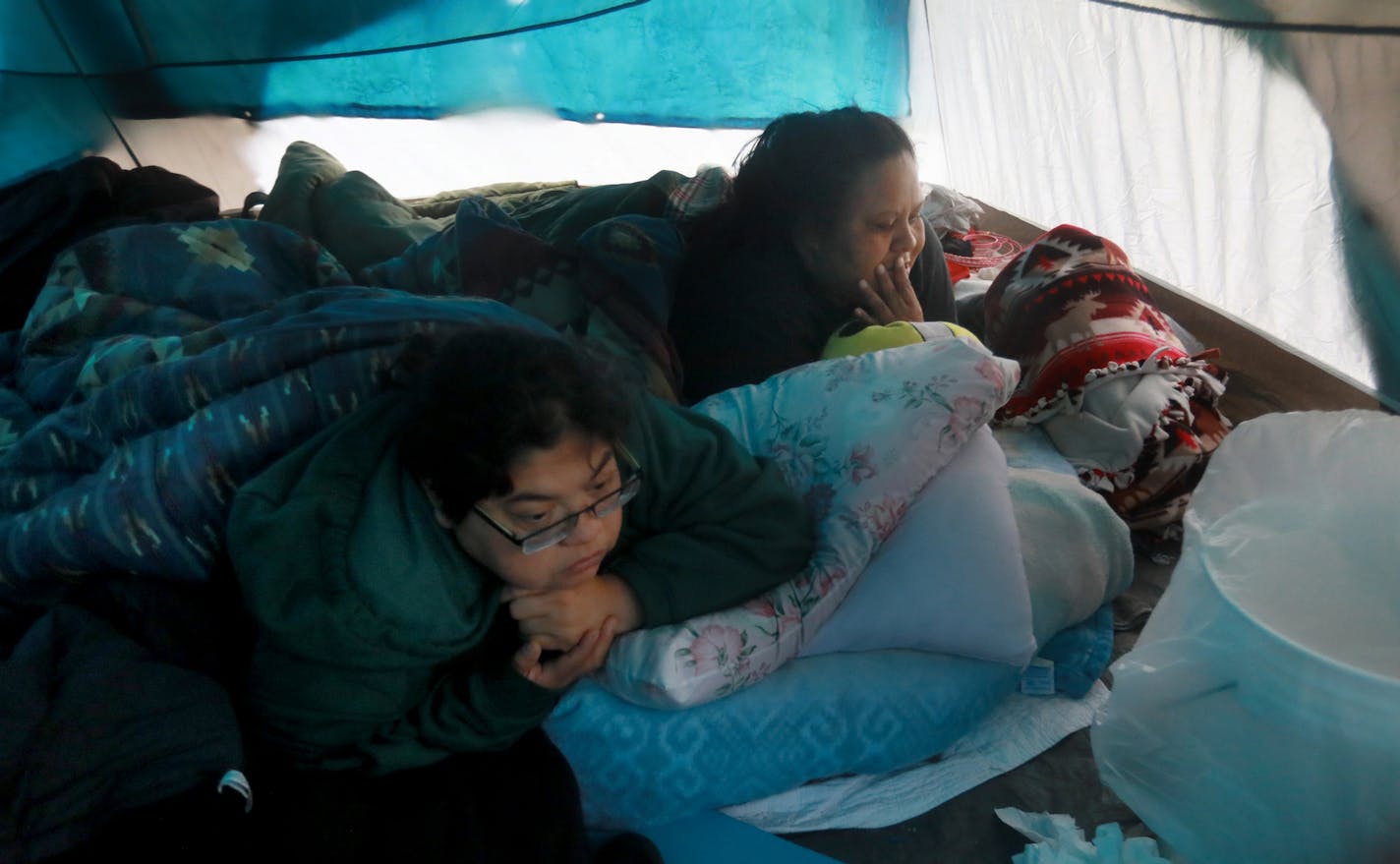 Ellen Dick, right, has been drug-free for almost a year. Here she tried to stay warm in a tent with friend Mona Richards.