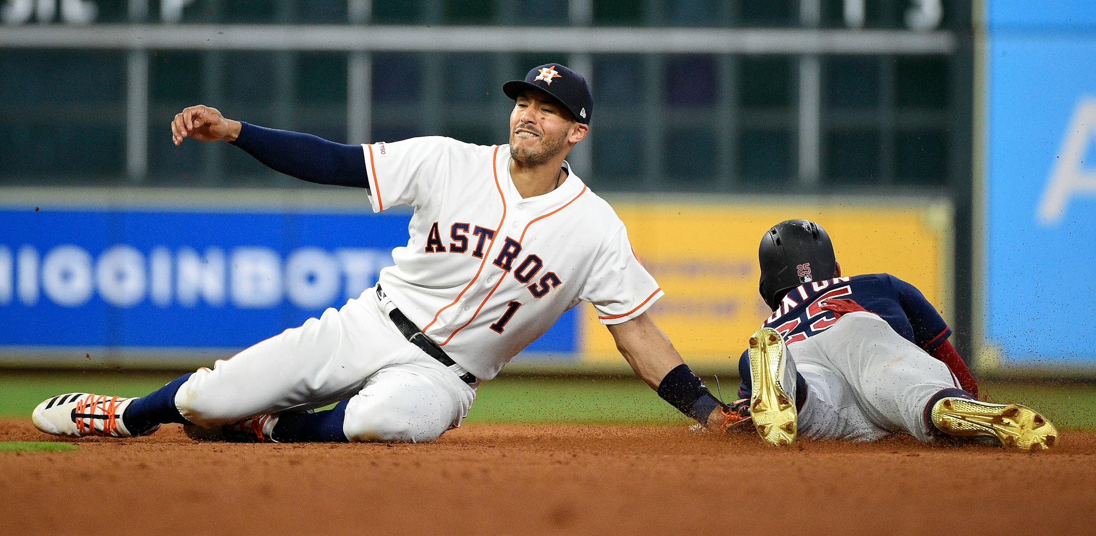 Astros shortstop Carlos Correa tags out the Twins' Byron Buxton on Monday.