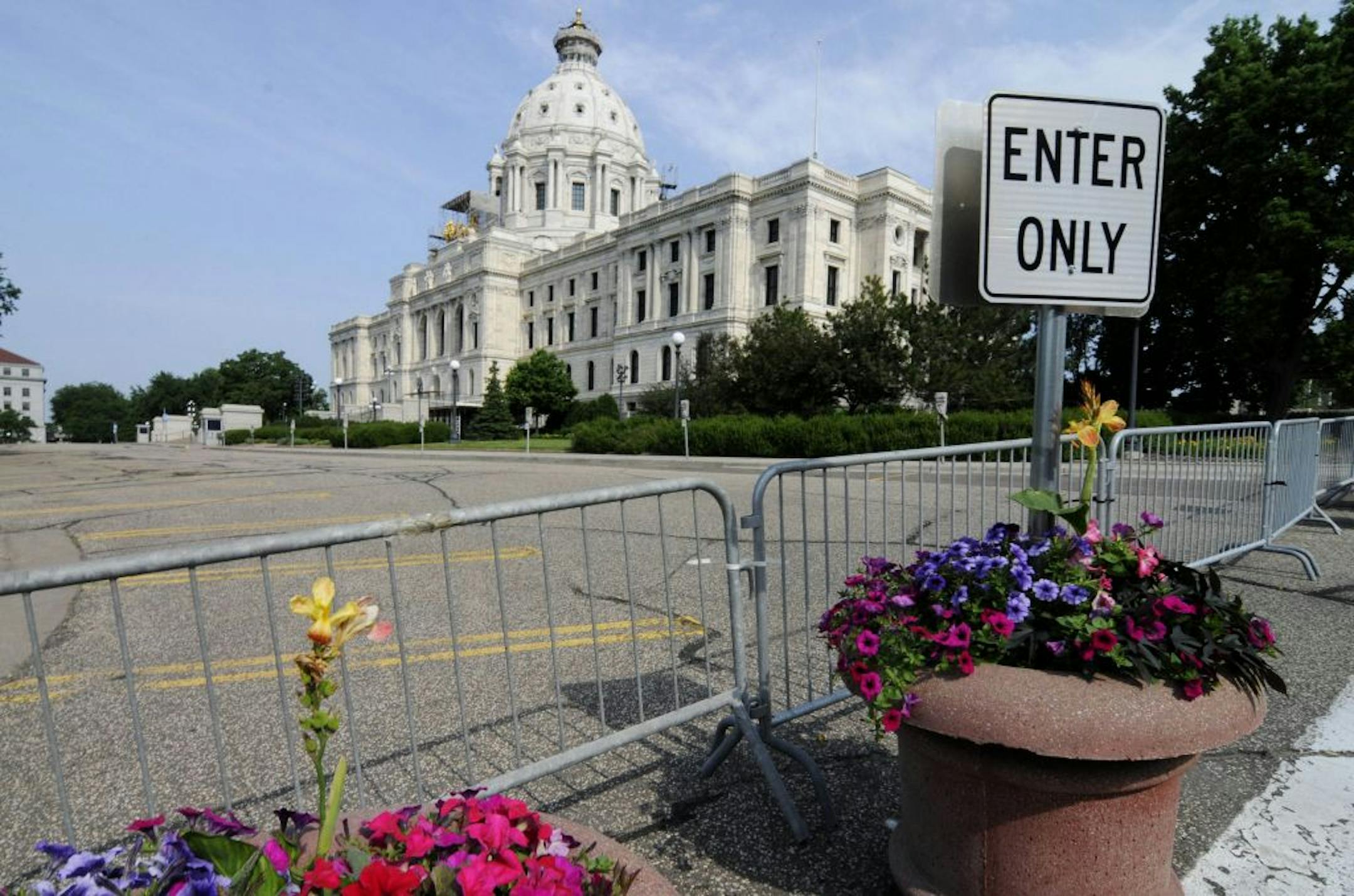Barriers were in place on the road in front of the Minnesota State Capitol Friday, July 1, 2011 in St. Paul, Minn., after negotiations over the state budget between Republican lawmakers and Democratic Gov. Mark Dayton broke down and the government shutdown at midnight. AP Photo/Jim Mone)