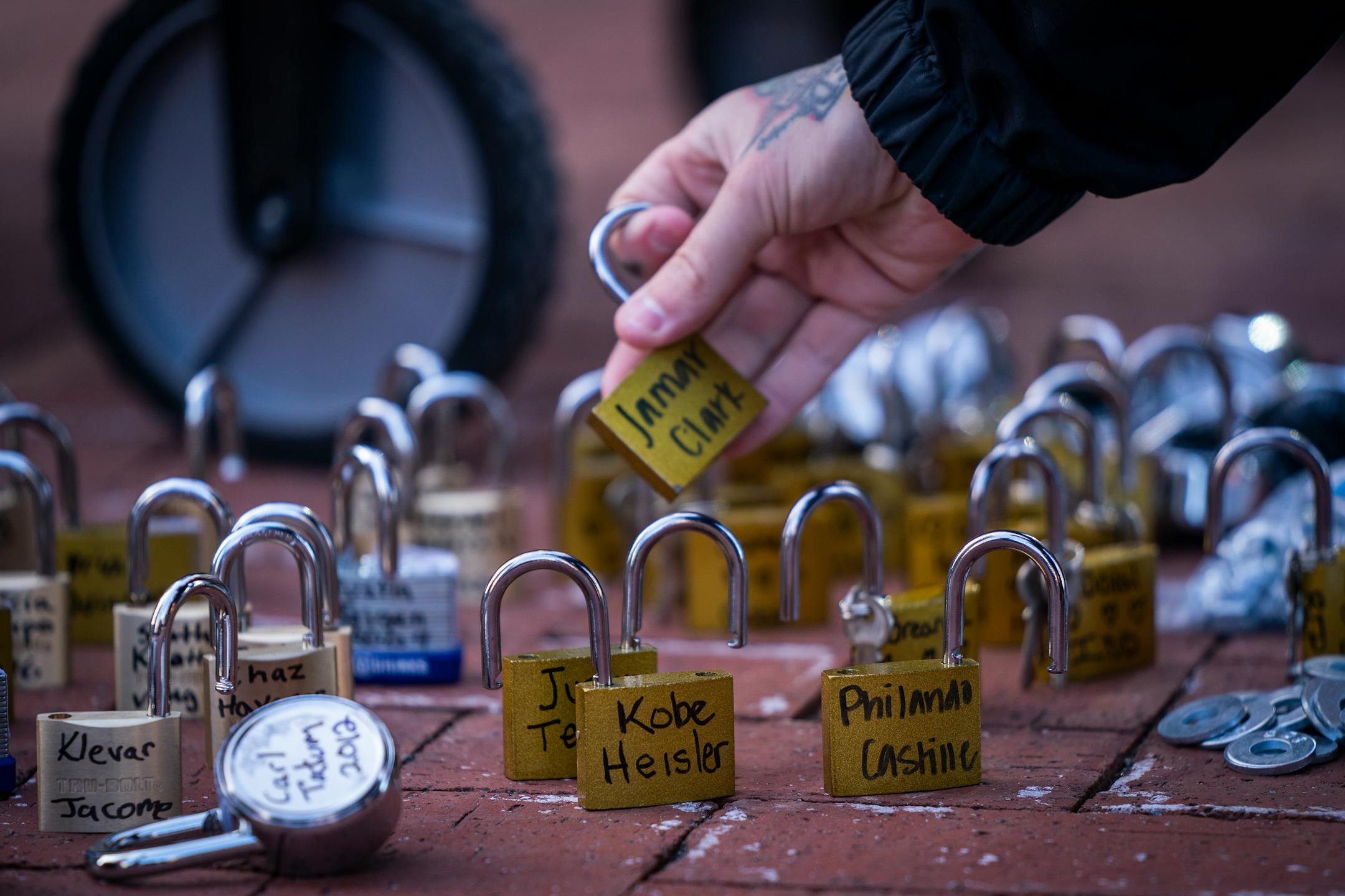 People placed locks with the names of those killed by law enforcement in Minnesota on the fence outside the Hennepin County Government Center during the Locks for Loved Ones Lost: Part II event.