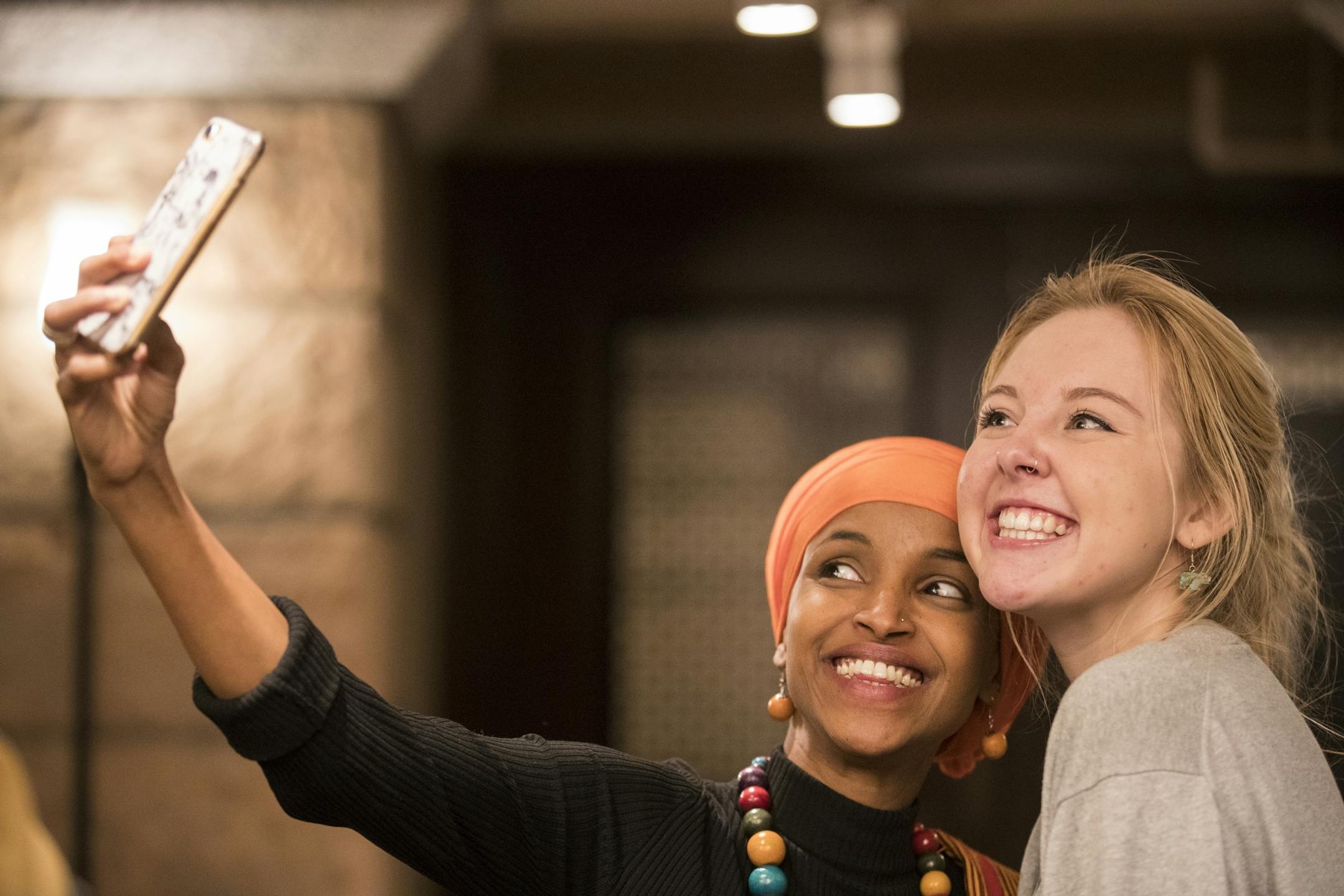 Rep. Ilhan Omar, DFL-Minneapolis, poses for a selfie with Alaina Friedrich.