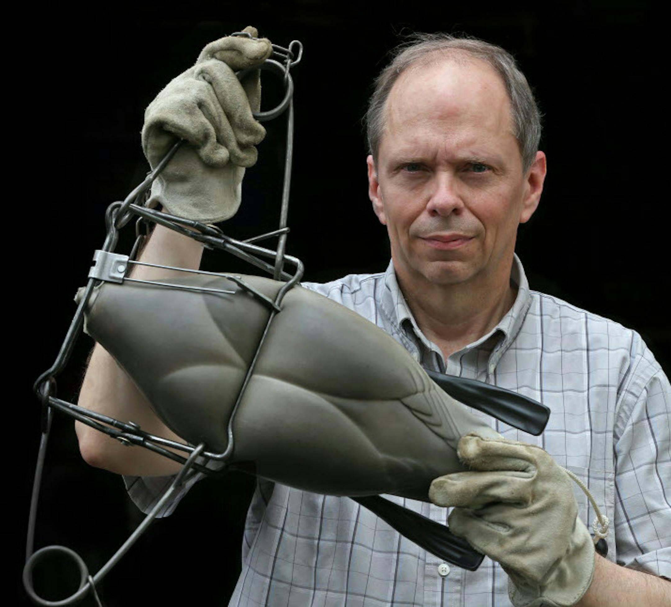 Kevin Auslund held a Conibear trap sprung on a goose decoy, showing the force of the trap when tripped. Auslund is fighting the DNR's position that trapping is legal on the new state Walk-In Access lands. ORG XMIT: MIN1407101610540855