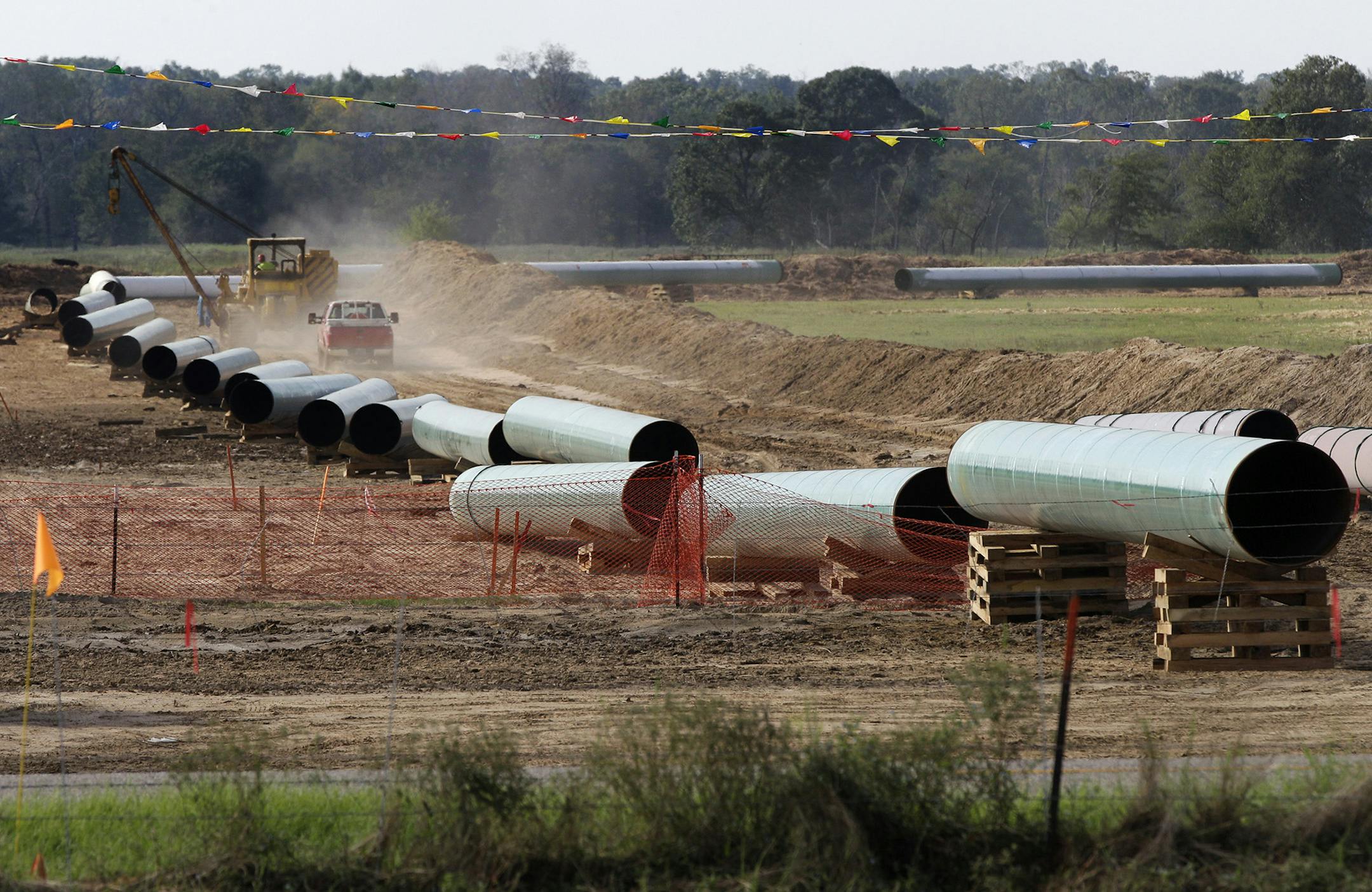 This 2012 photo shows large sections of pipe neighboring property to Julia Trigg Crawford family farm, in Sumner Texas. On Wednesday, Jan 22, 2014, TransCanada said in a statement on its website that it is delivering oil through the Gulf Coast portion of its proposed Keystone XL pipeline, from a hub in Cushing, Okla., to Houston-area refineries.