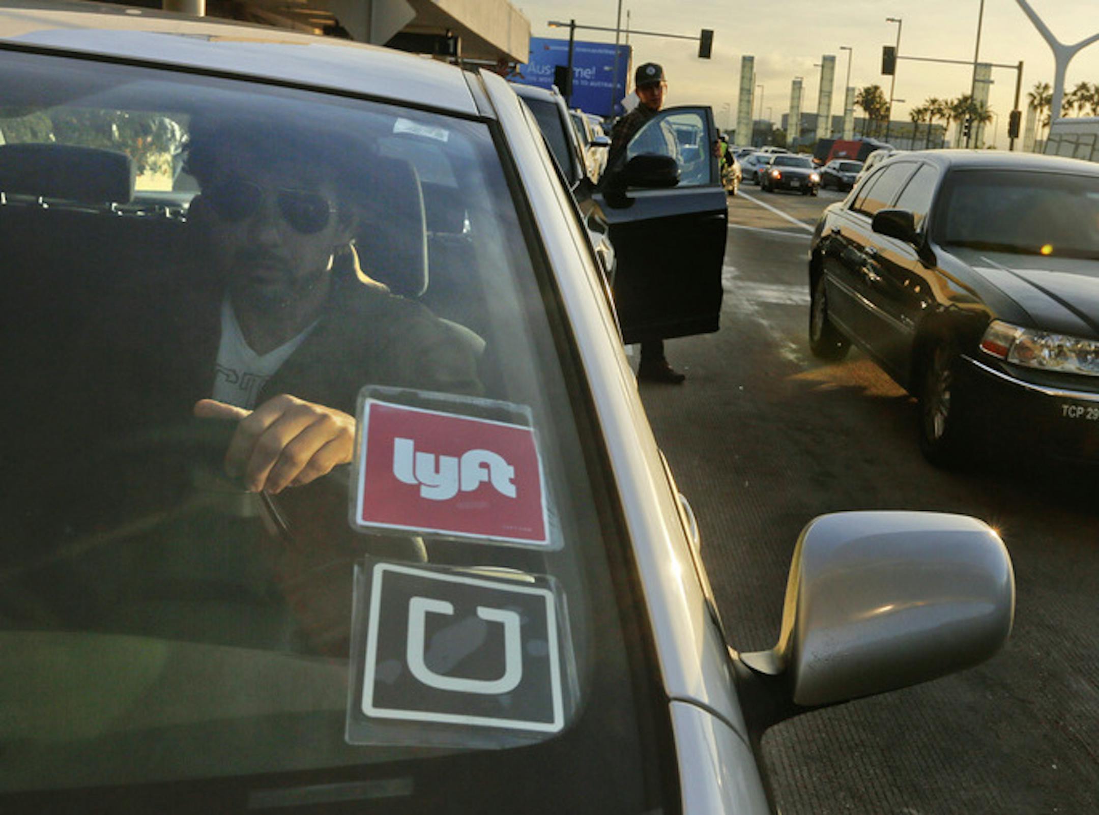From January 2014 to January 2015, Lyft grew fivefold in rides and revenue. Above, a driver for Lyft and Uber at Los Angeles International Airport last month. (Mark Boster/Los Angeles Times/TNS) ORG XMIT: 1178954