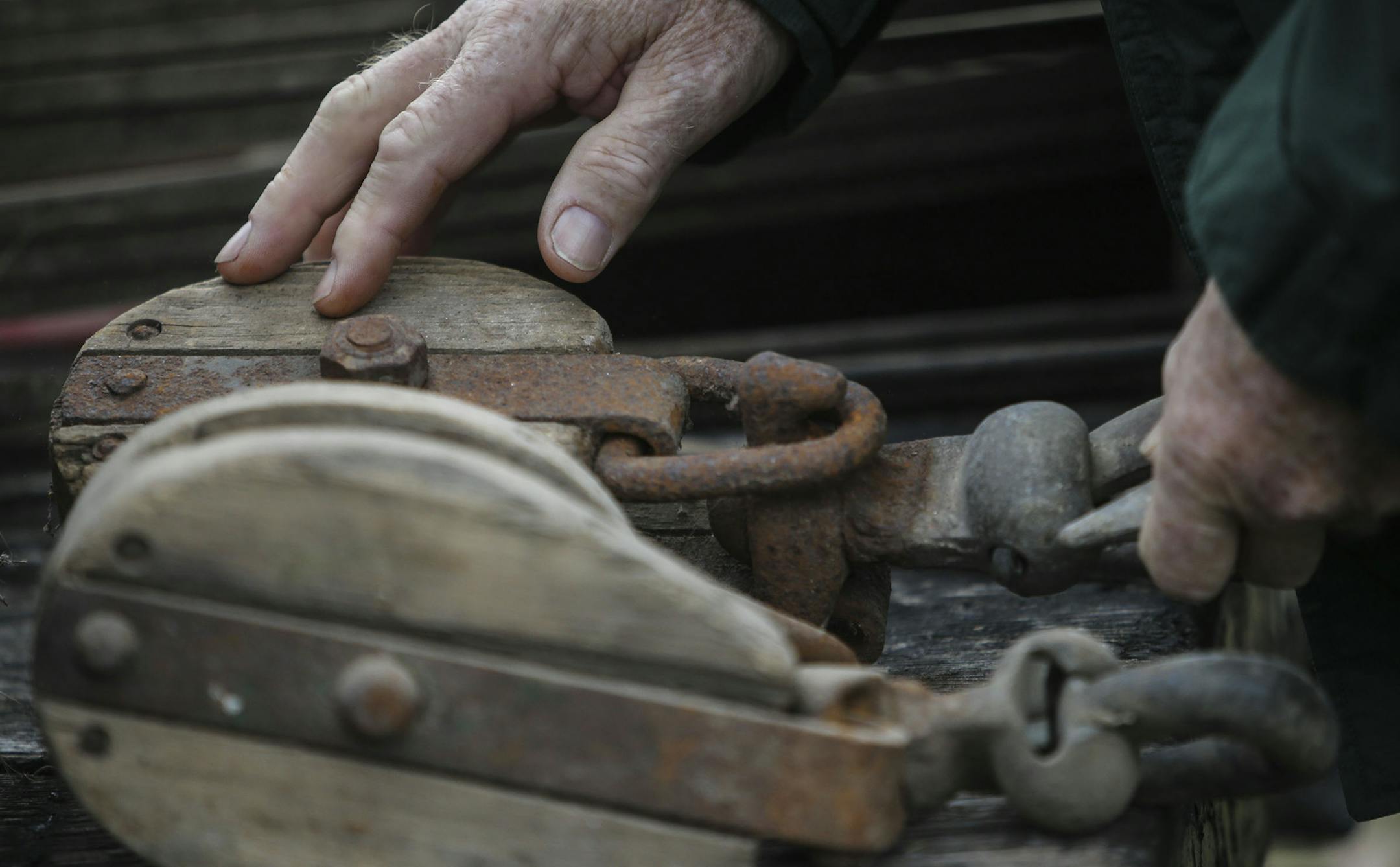Wayne Schilling, a fifth-generation farmer in Woodbury, and his wife, Betty, auctioned off all their farm equipment and machinery Saturday, Oct. 4, 2014, in Woodbury. Here, a man checks out an old wood pulley before the start of the auction.](DAVID JOLES/STARTRIBUNE)djoles@startribune.com Wayne Schilling, a fifth-generation farmer in Woodbury, has sold the last 130 acres of the family farm and one of the last farms in Woodbury to developers. Wayne and his wife, Betty, auctioned off all their far
