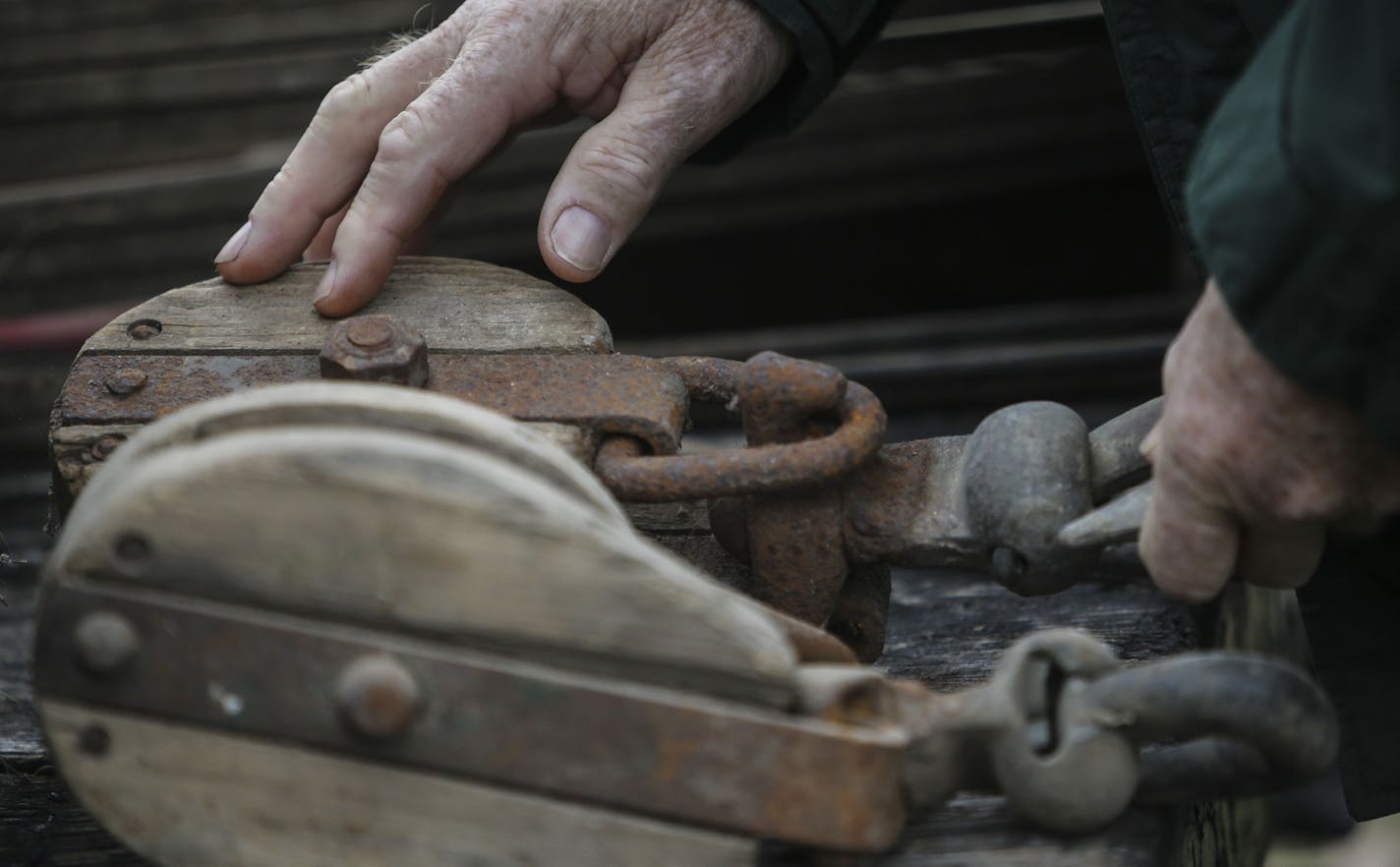 Wayne Schilling, a fifth-generation farmer in Woodbury, and his wife, Betty, auctioned off all their farm equipment and machinery Saturday, Oct. 4, 2014, in Woodbury. Here, a man checks out an old wood pulley before the start of the auction.](DAVID JOLES/STARTRIBUNE)djoles@startribune.com Wayne Schilling, a fifth-generation farmer in Woodbury, has sold the last 130 acres of the family farm and one of the last farms in Woodbury to developers. Wayne and his wife, Betty, auctioned off all their far