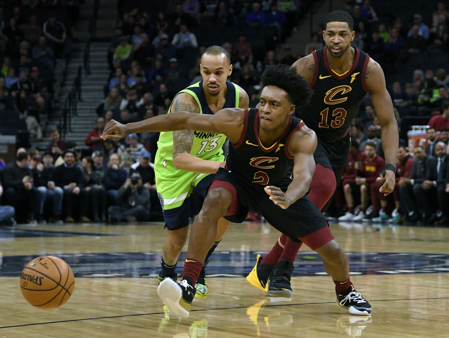 Minnesota Timberwolves' Shabazz Napier (13) and Cleveland Cavaliers' Collin Sexton (2) go after a loose ball as Cleveland Cavaliers' Tristan Thompson (13) watches during the first quarter of an NBA basketball game on Saturday, Dec. 28, 2019, in Minneapolis. (AP Photo/Hannah Foslien)