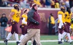 Minnesota Golden Gophers head coach Tracy Claeys ran onto the field after Minnesota's 32-23 victory over the Illinois Fighting Illini Saturday.