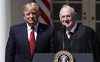 FILE - In this April 10, 2017, file photo, President Donald Trump, left, and Supreme Court Justice Anthony Kennedy participate in a public swearing-in