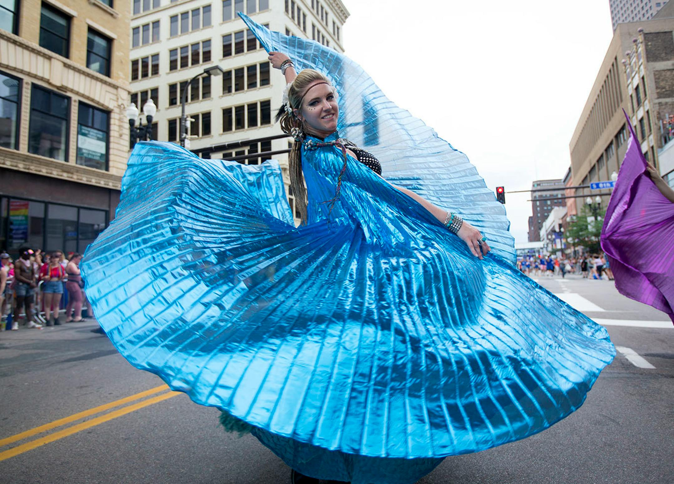 Alyssa Adair danced with a group in colorful winged costumes at the pride parade, Sunday, June 24 2018.