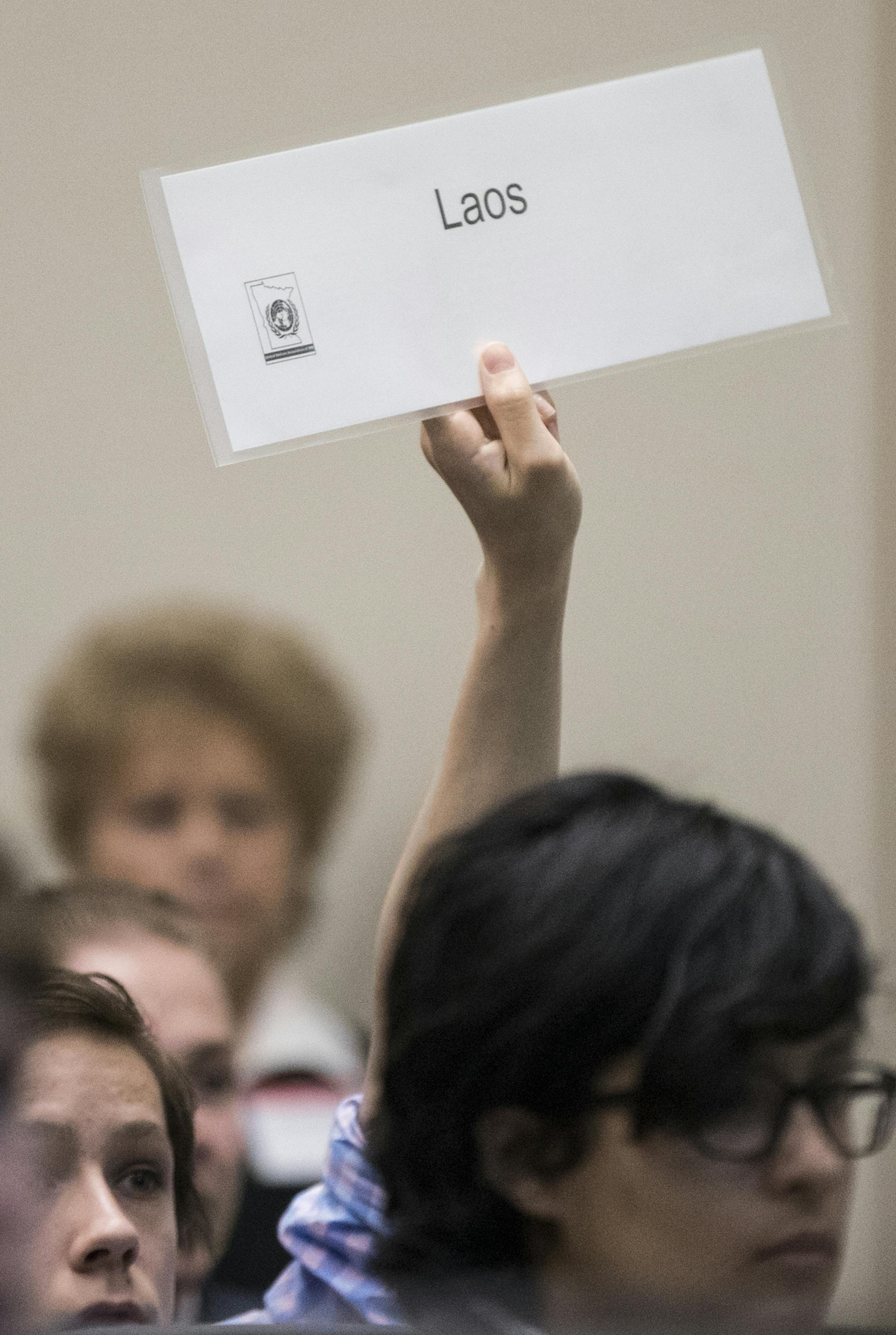 A student held up their country during role call during a Spanish-language model UN, the only one of its kind in the nation, at Cargill in Wayzata, Minn., on Tuesday, April 18, 2017. ] RENEE JONES SCHNEIDER • renee.jones@startribune.com
