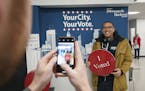 Jared Mollenkof has his photo taken after voting at the Minneapolis Early Voting Center, Friday, Jan. 17, 2020, in Minneapolis. Mollenkof and Davis Se