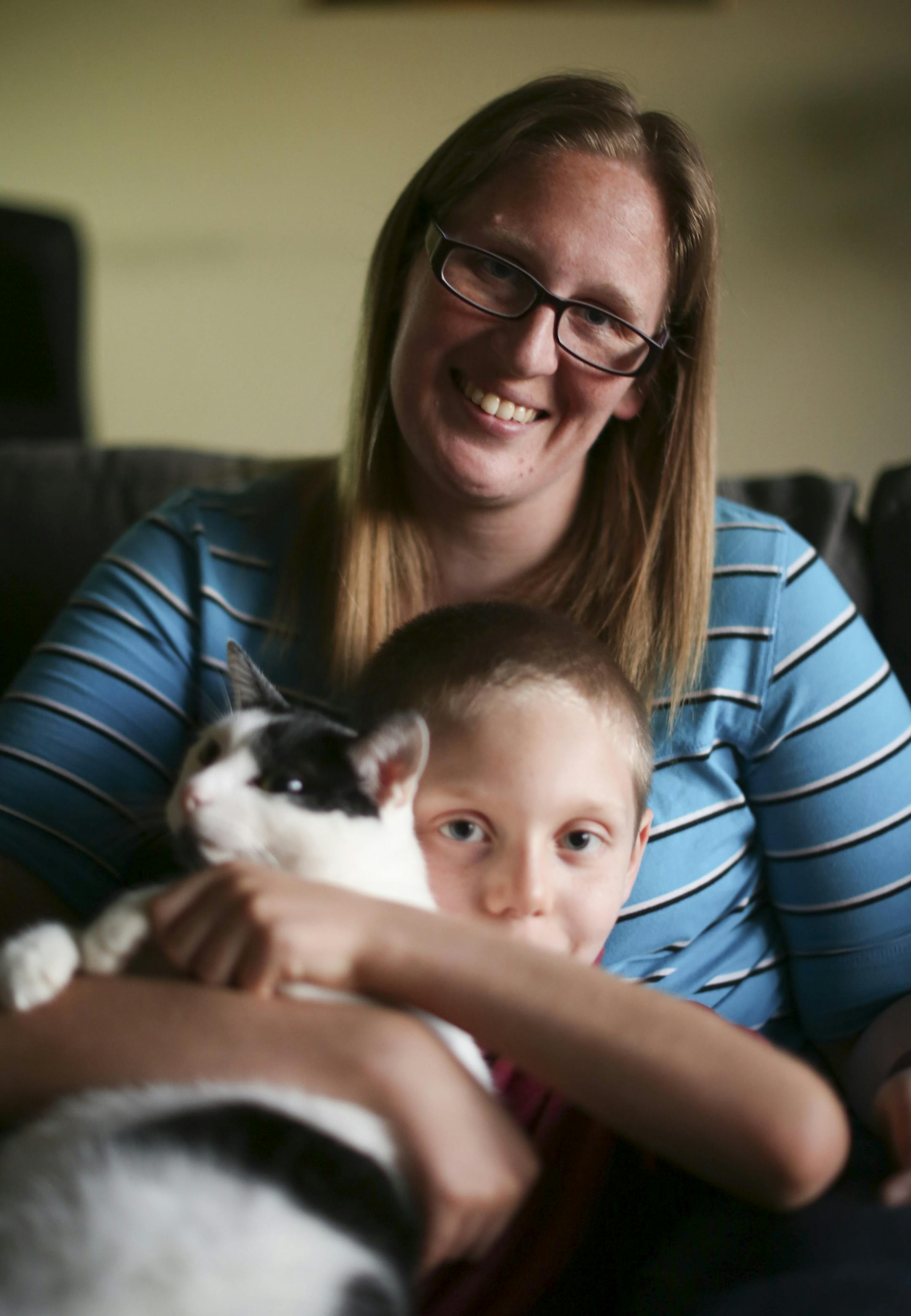Heidi Mouw and her son with his therapy cat, Dakota, in the living room of their Shoreview home Monday night. ] JEFF WHEELER • jeff.wheeler@startribune.com After Heidi Mouw posted online about her young son's thoughts of suicide, she received a wave of support – something professionals say parents with kids with mental illness don't often receive. In their Shoreview home Monday evening, August 22, 2016, Heidi and her husband, Dan, played board games with their eight year-old son.