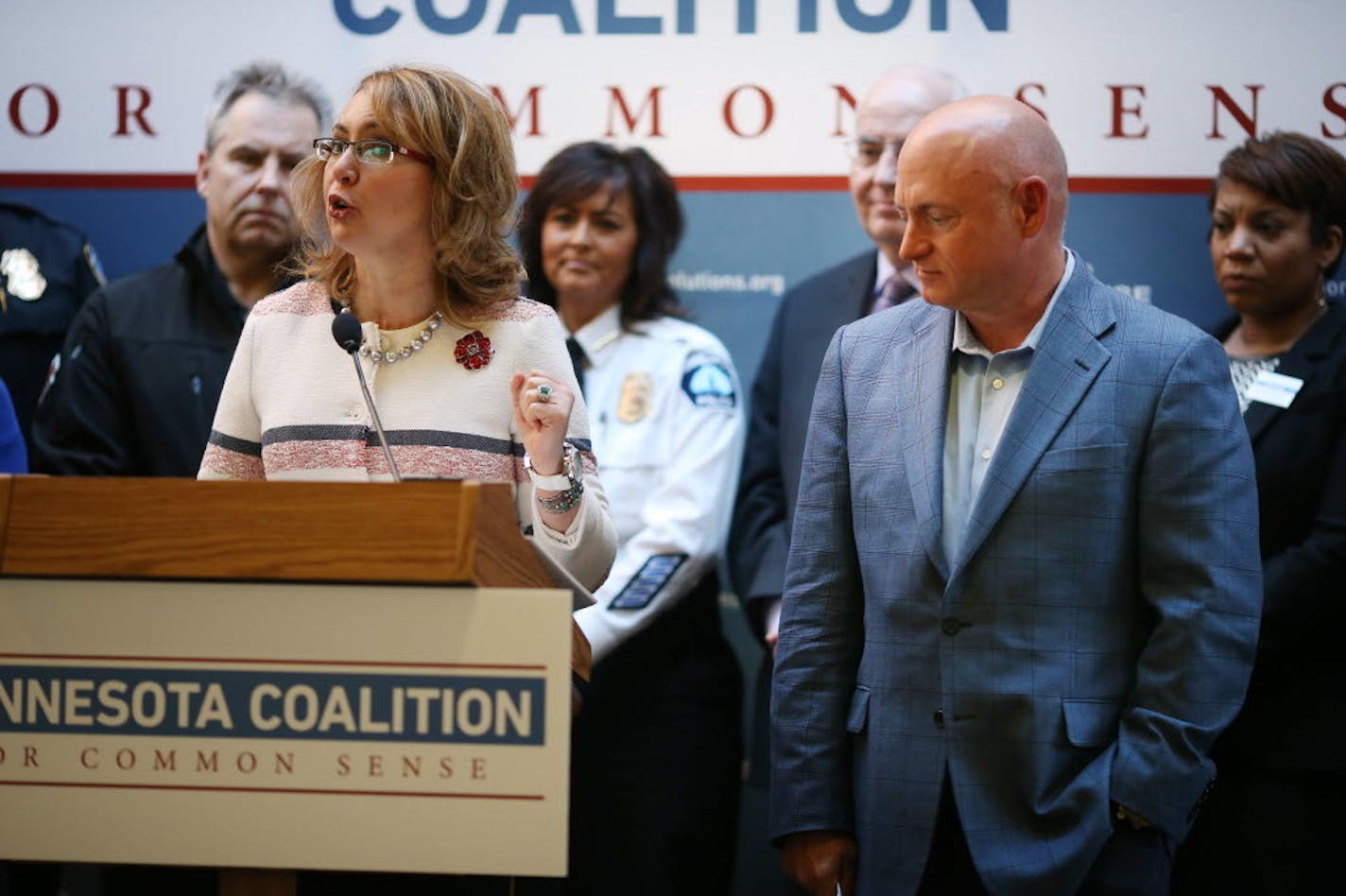 Gabrielle Giffords spoke as her husband, Mark Kelly, stood by during a press conference Thursday for the Minnesota Coalition for Common Sense at Augsburg College in Minneapolis.