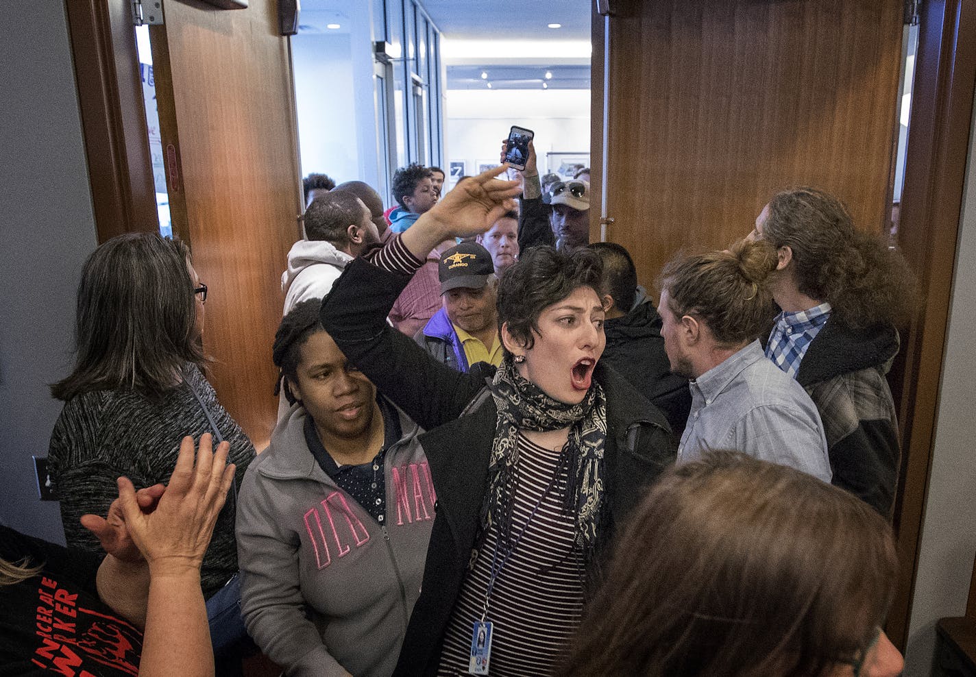 A group that was initially barred from entering the meeting room because of overcapacity entered before the start of a Minneapolis school board meeting at the John B. Davis Education and Service Center. ] CARLOS GONZALEZ &#xef; cgonzalez@startribune.com - April 18, 2017, Minneapolis, MN, outrage over Minneapolis Public School board cuts. Protest at School Board Meeting.