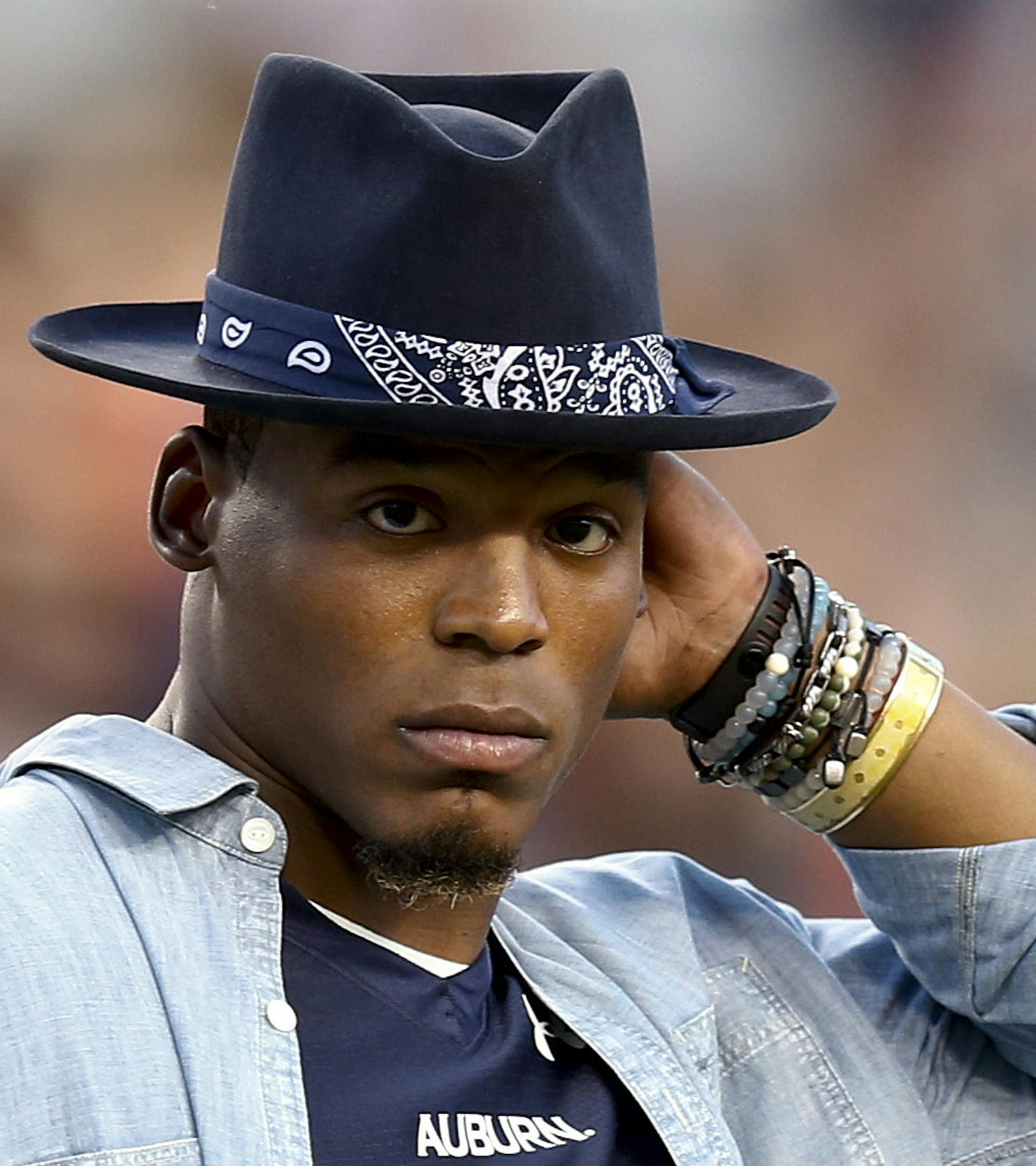 Carolina Panthers quarterback Cam Newton watches Auburn and Clemson football practice before an NCAA college football game, Saturday, Sept. 3, 2016, in Auburn, Ala. (AP Photo/Brynn Anderson)