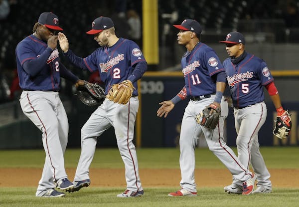 Minnesota Twins third baseman Miguel Sano, left, celebrates with second baseman Brian Dozier, second left, after their win over the Chicago White Sox 