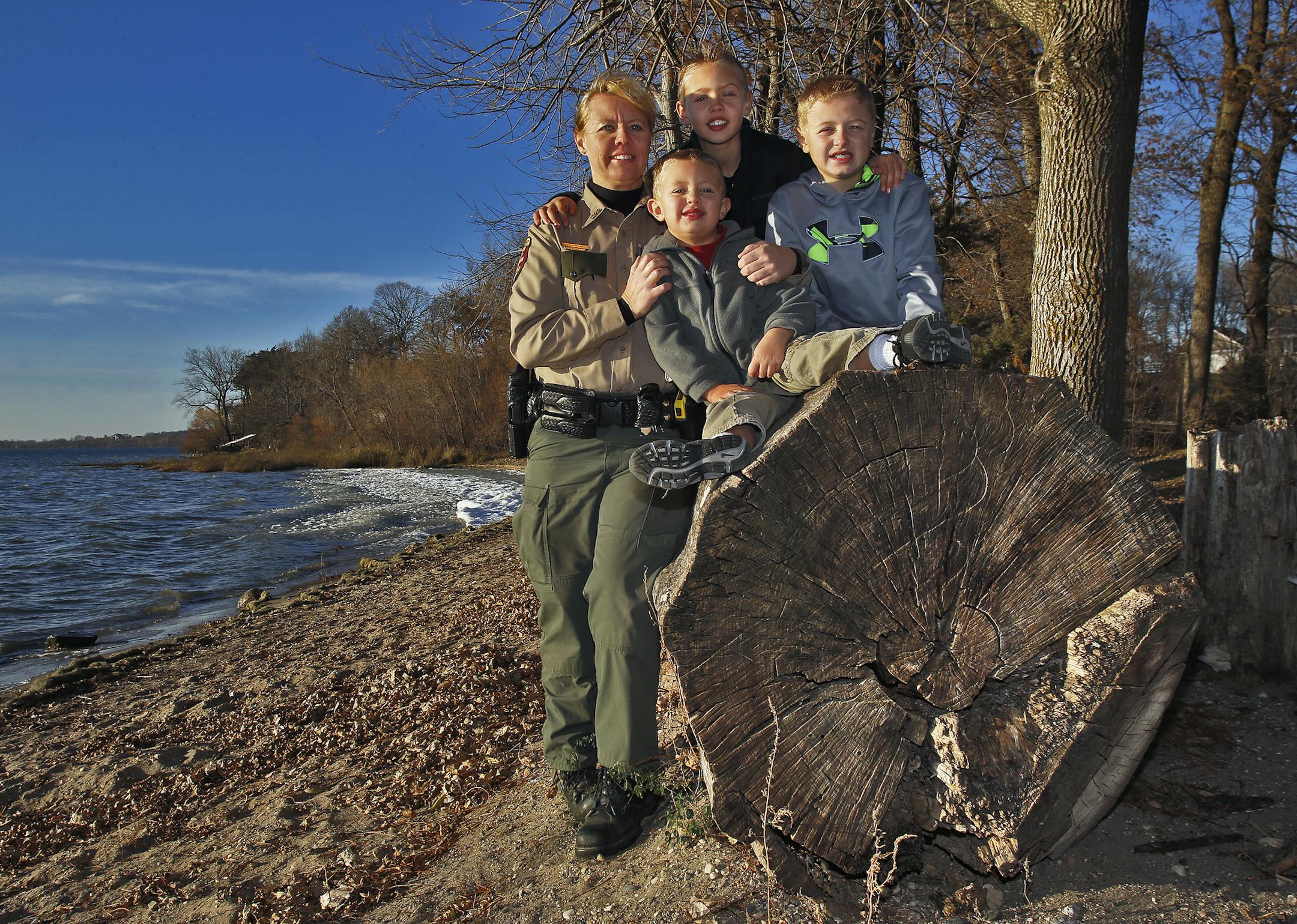 Jackie Glaser is a Minnesota DNR officer working on the west side of the Twin Cities. Glaser juggles her work duties with the responsibilities of being a mother of three young sons. Photos taken on the shore of Lake Waconia. Jackie Glaser with sons Brady Glaser, 5, Ryan Glaser, 9, and Brady Glaser, 11, l-r. (MARLIN LEVISON/STARTRIBUNE(mlevison@startribune.com)