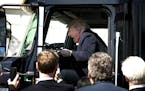 President Donald Trump jokes like he&#xed;s driving after he jumped into the driver&#xed;s seat of a semi-trailer truck on the South Grounds of the Wh