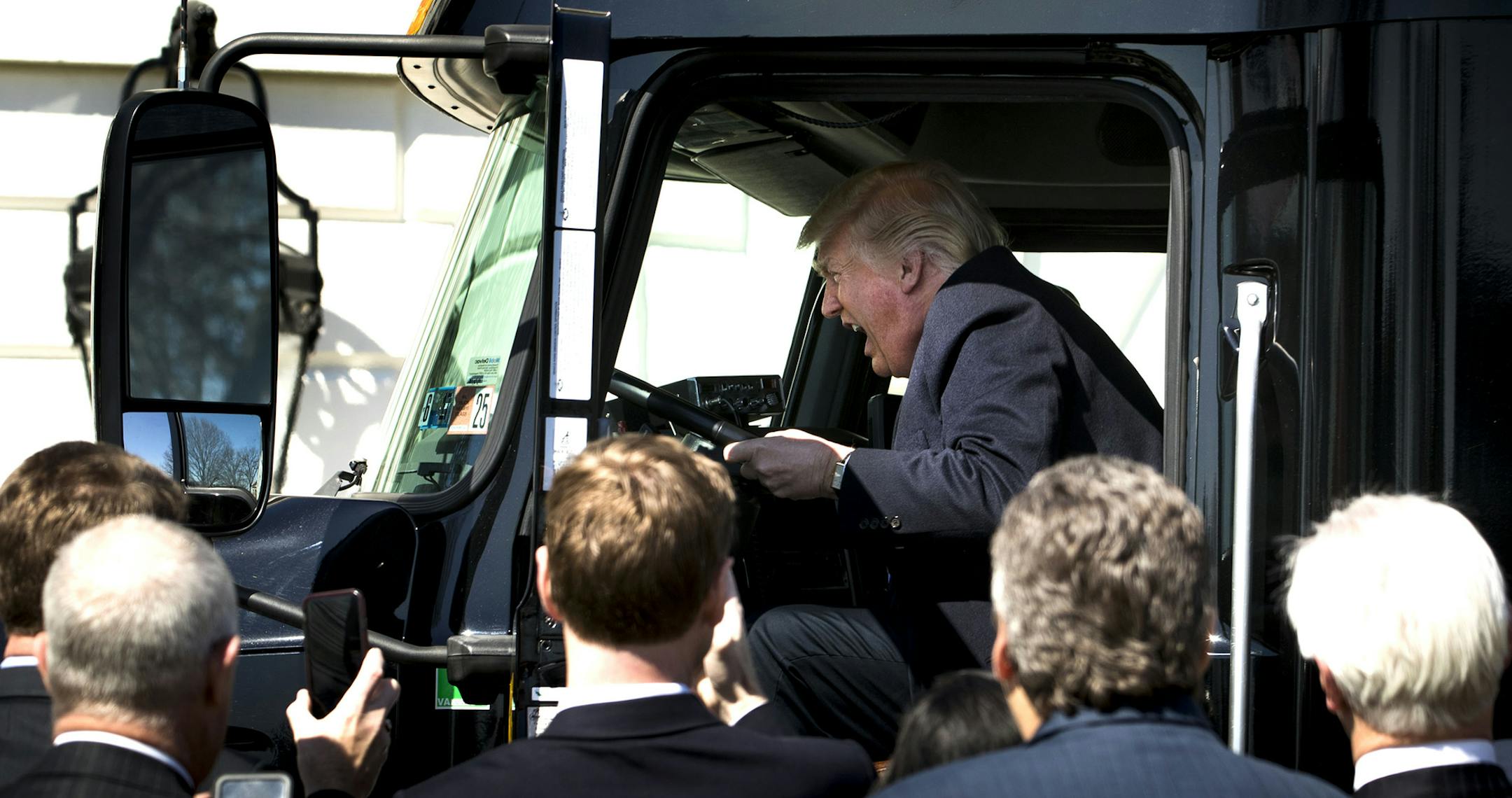 President Donald Trump jokes like heís driving after he jumped into the driverís seat of a semi-trailer truck on the South Grounds of the White House as he welcomes truckers and chief executives to a listening session on healthcare, March 23, 2017. (Doug Mills/The New York Times) ORG XMIT: MIN2017032315575100