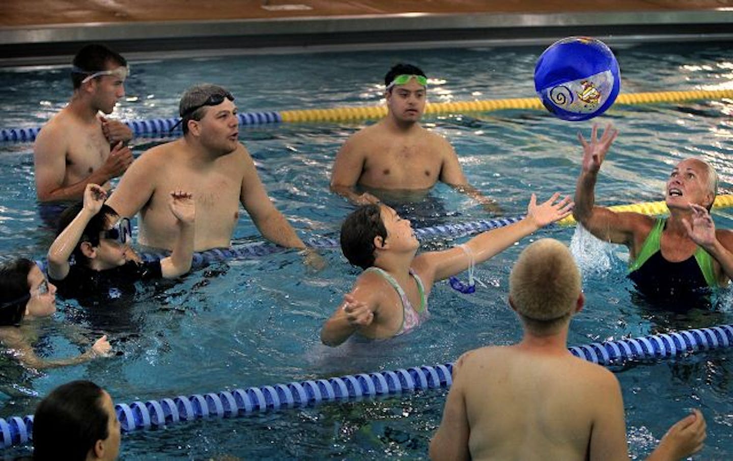 Coach Debbie Townsend, right, played ball with the swimmers.