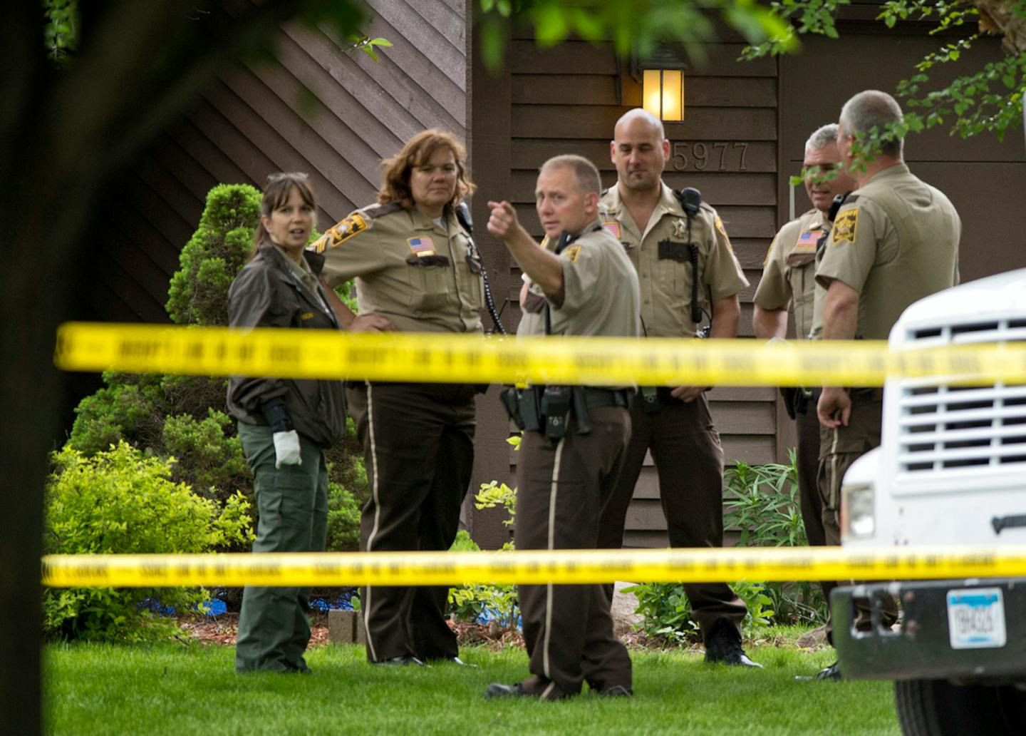 Scene in front of a single family home on the 5900 block of Grotto St. N, Shoreview, where two people were shot and killed Tuesday, June 4, 2013