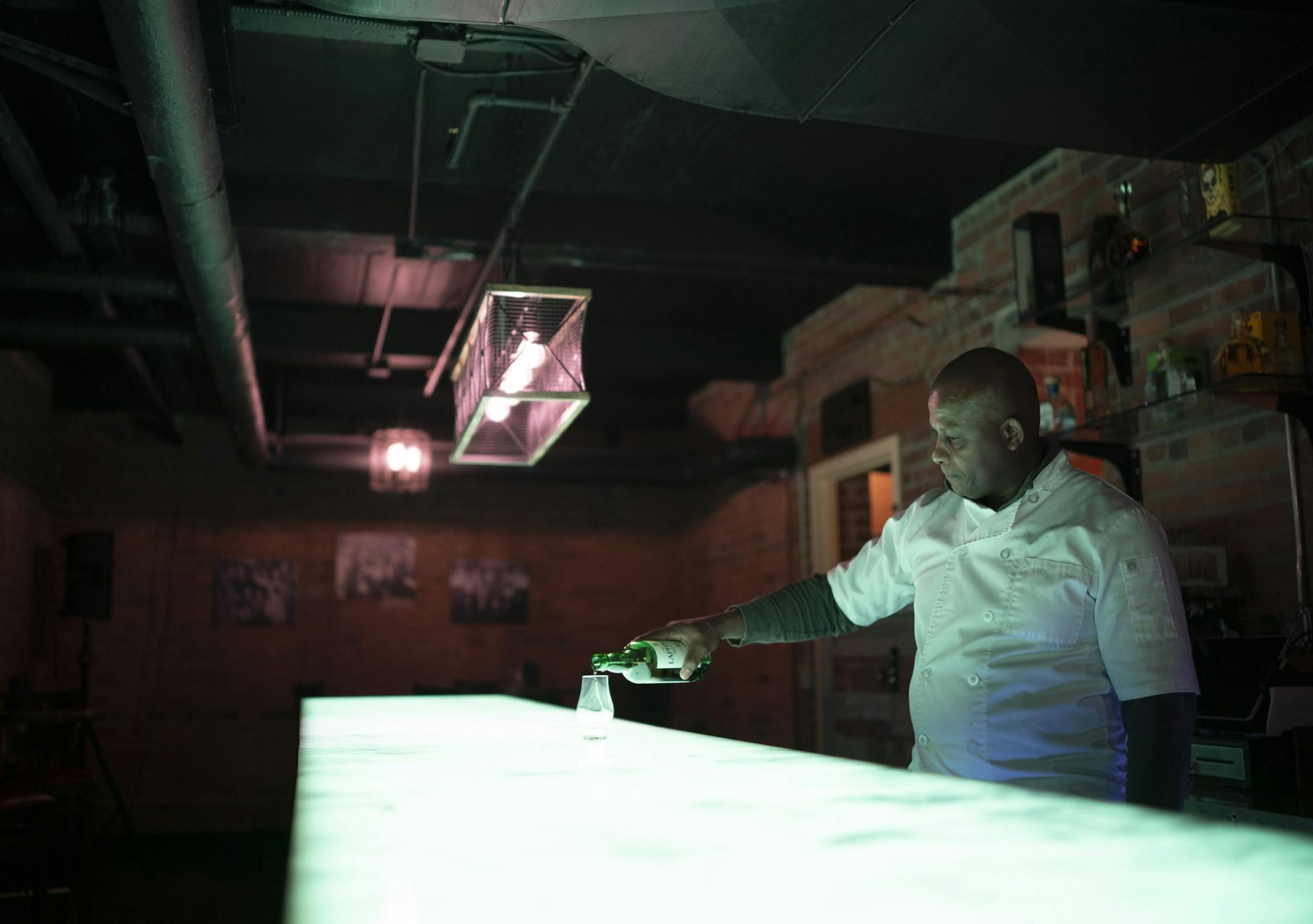 Nucky's Speakeasy co-owner Rowan Brown poured himself a splash of whiskey in the basement bar.