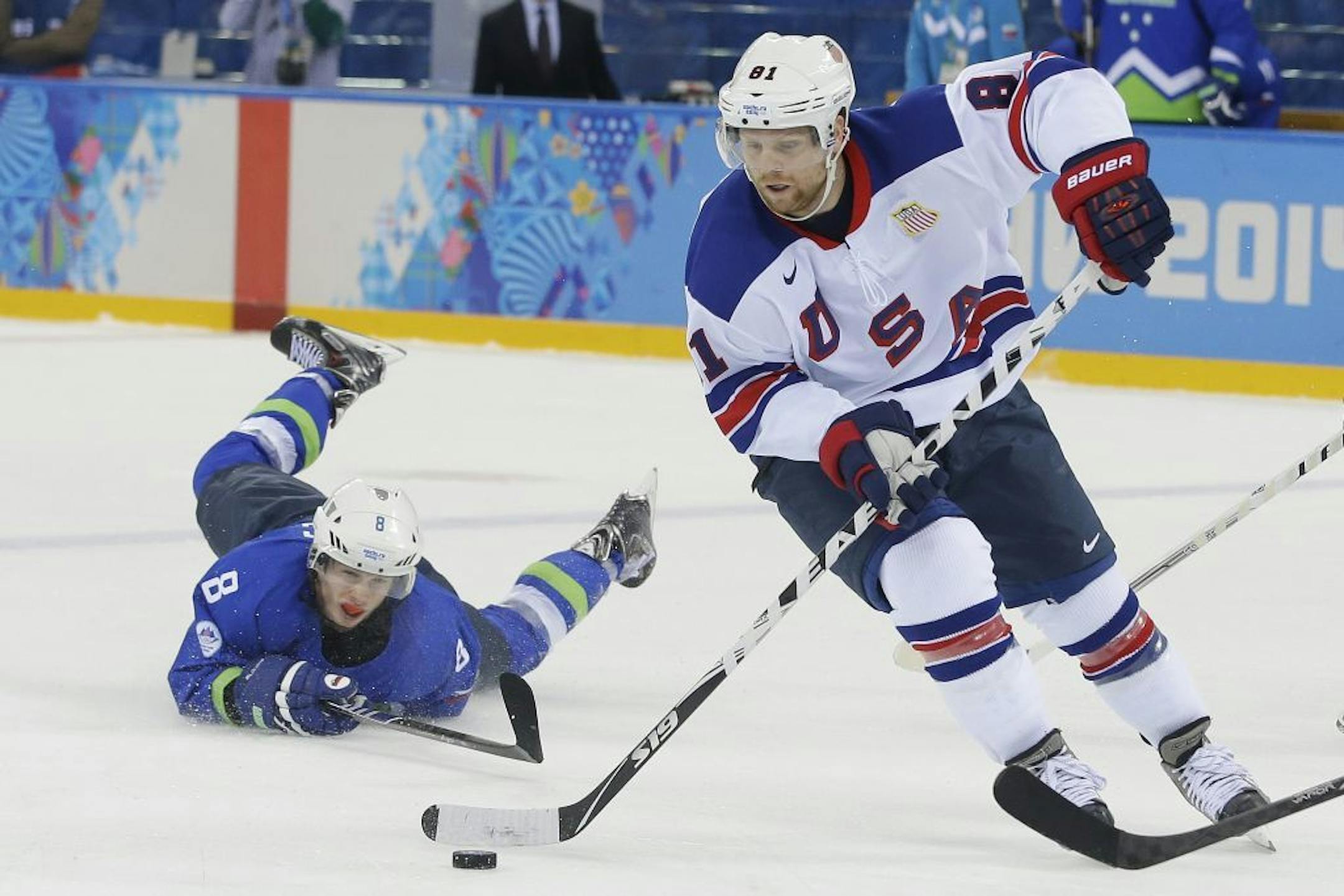 USA forward Phil Kessel took the puck away from Slovenia forward Ziga Jeglic during the 2014 Winter Olympics men's ice hockey game on Sunday.