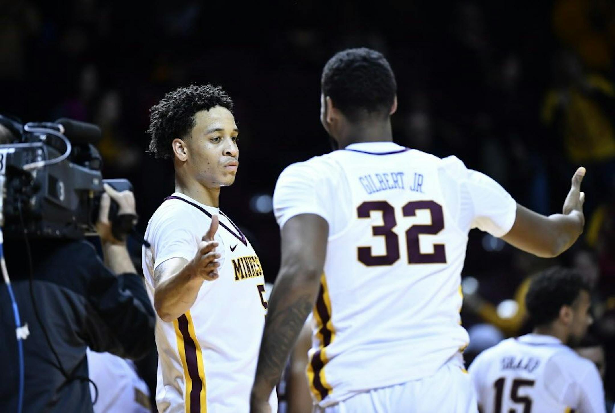 Minnesota Golden Gophers guard Amir Coffey (5) high fived guard Ahmad Gilbert (32) after their team's 85-71 victory over the Arkansas Razorbacks.