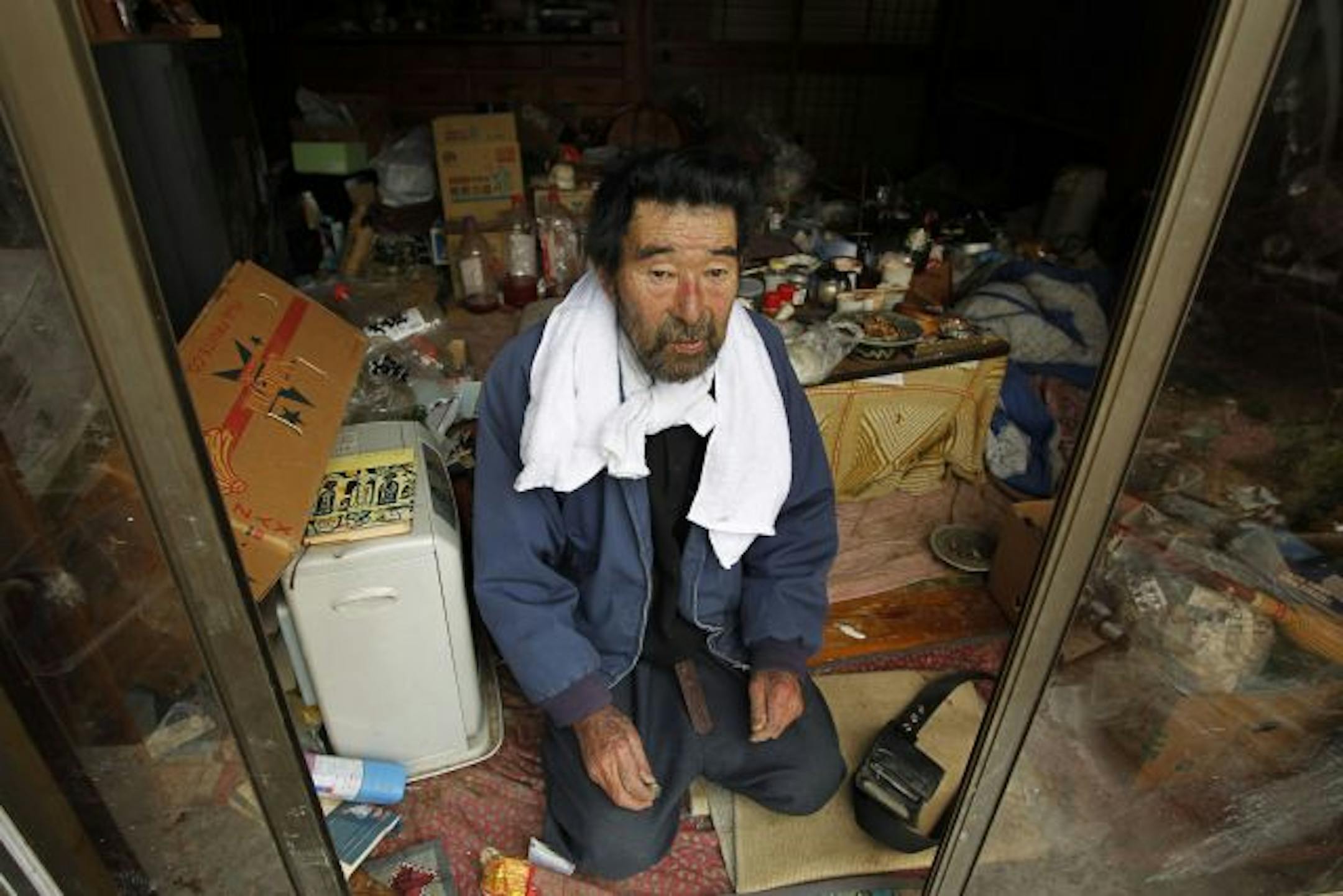 Kunio Shiga poses for a photo at his home in Minami Soma, Fukushima Prefecture, inside the deserted evacuation zone established for the 20 kilometer radius around the Fukushima Dai-ichi nuclear complex in northeastern Japan Friday, April 8, 2011. The 75-year-old man was stranded alone in his farmhouse ever since Japan's monstrous tsunami struck nearly a month ago.