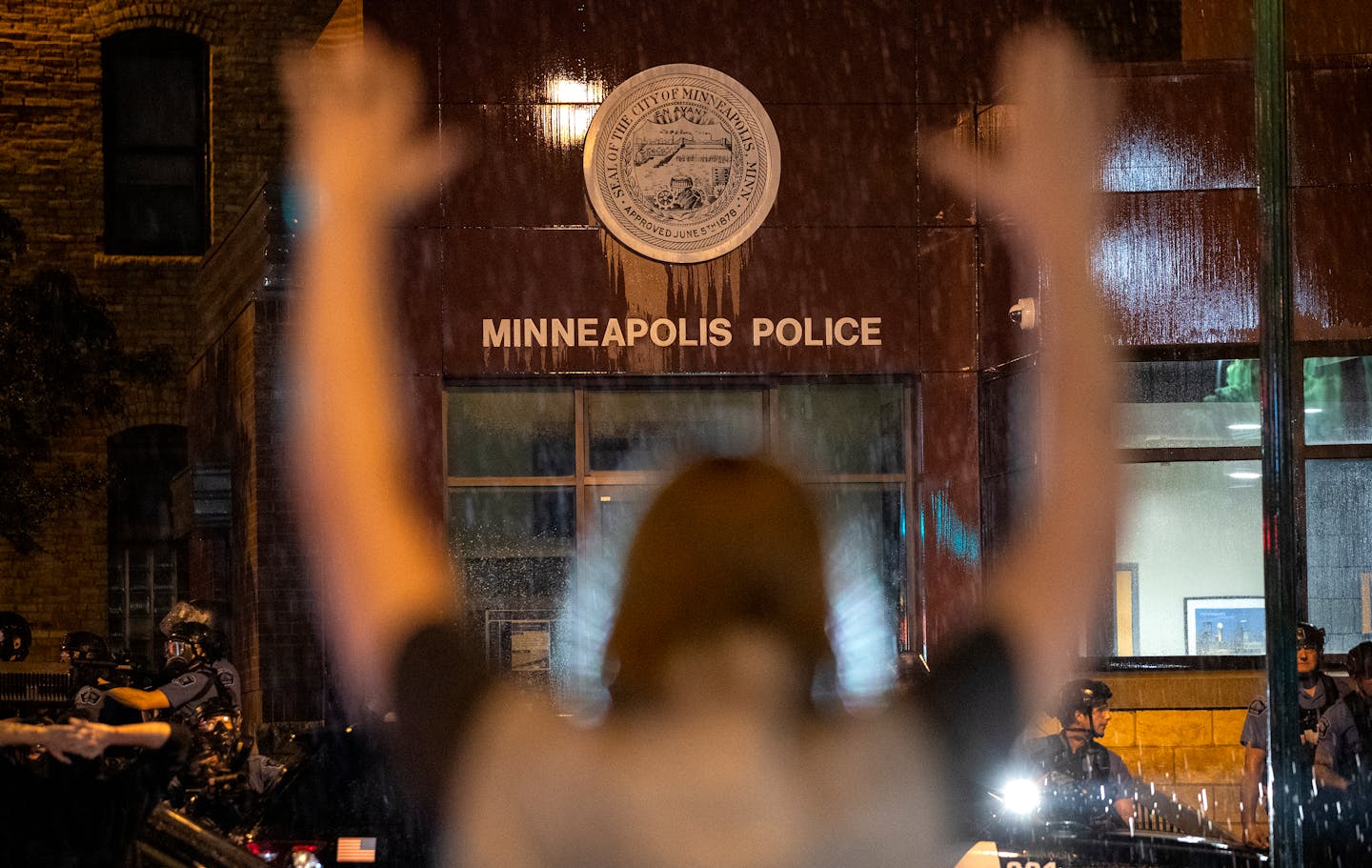 Protesters stood across from officers at the Minneapolis 3rd Police Precinct on May 26, 2020.