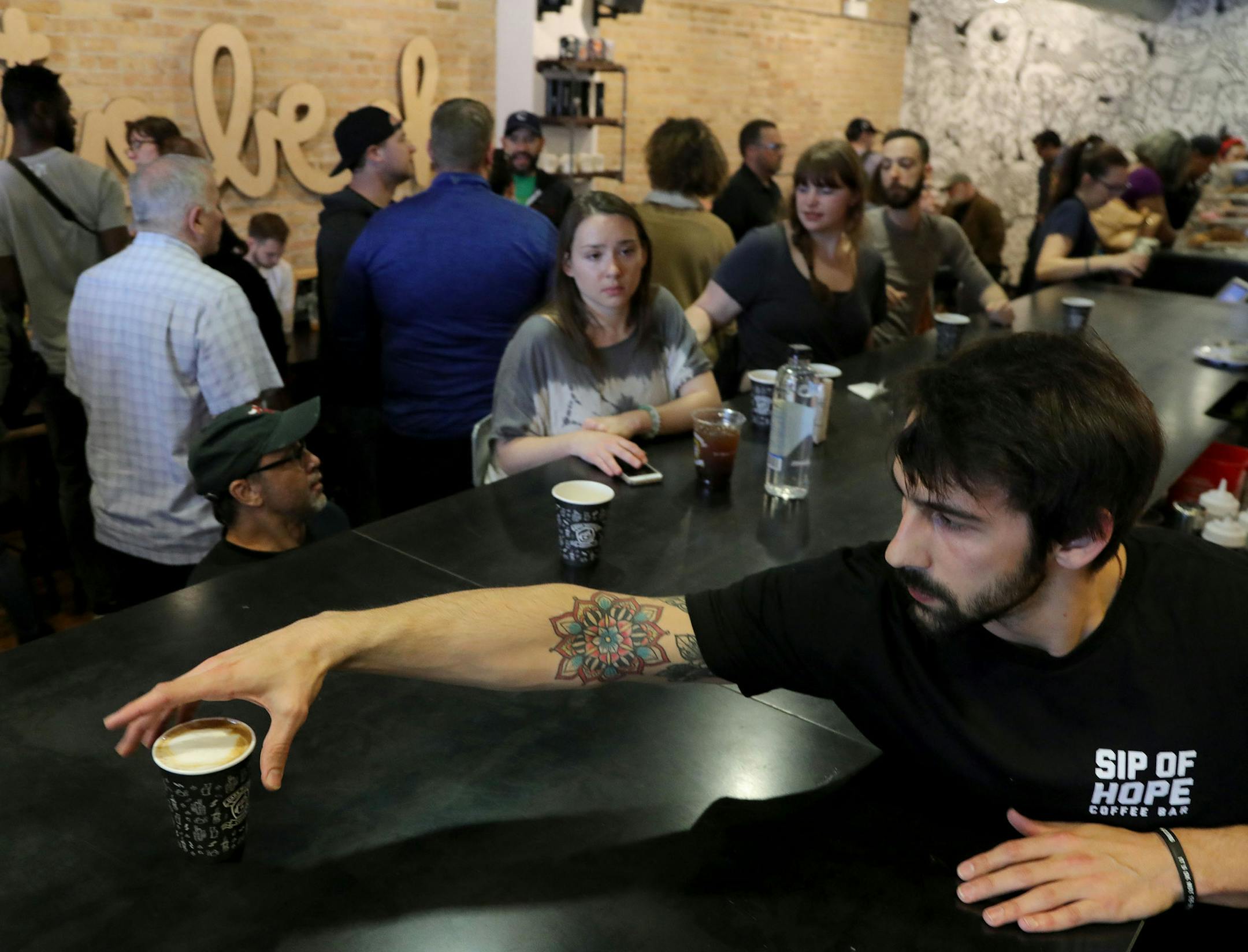 A place for help: Barista Brad Bacci prepared a drink as patrons gathered at Sip of Hope in Chicago. The shop seeks to draw people who simply want coffee but also those who need mental health help. Its mantra: "It's OK not to be OK."
