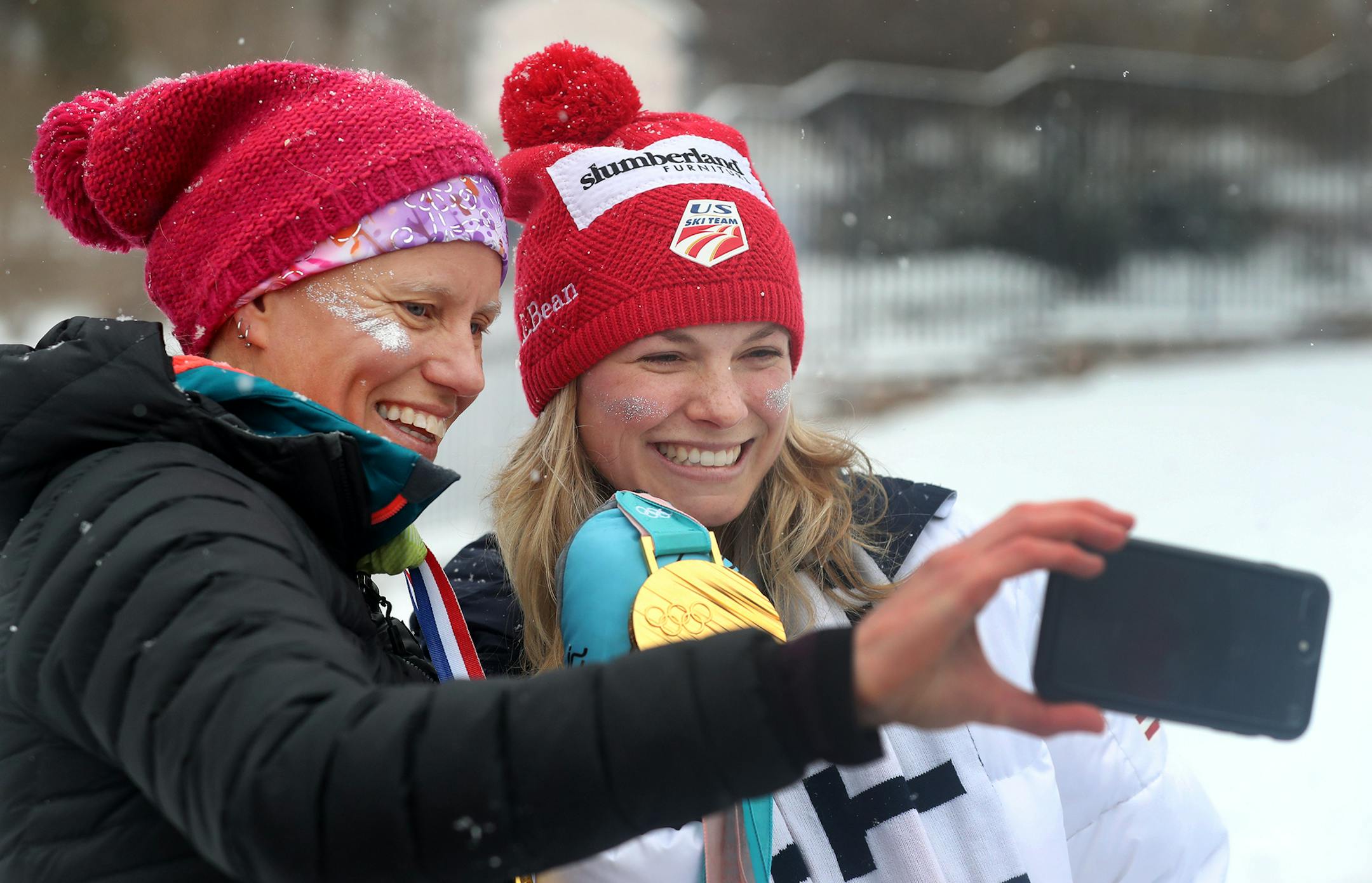 Jessie Diggins, team USA Olympic gold medalist cross country skier, poses for a selfie with Kris Hansen, her Stillwater High School cross country skiing coach, prior to a parade held in Diggins honor. Hundreds came out in snowy, blustery weather to honor Diggins and get a selfies taken with her Saturday, April 14, 2018, in Stillwater, MN.] DAVID JOLES ï david.joles@startribune.com