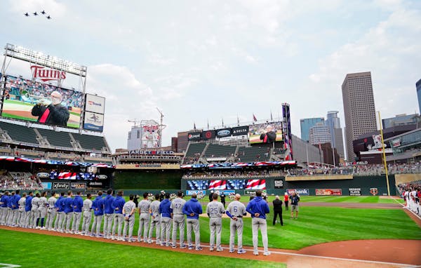 Four fighter jets fly over Target Field where players from the Twins and the Royals observed a moment of silence to mark the 20th anniversary of 9/11