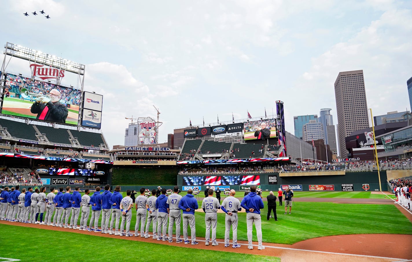 Four fighter jets fly over Target Field where players from the Twins and the Royals observed a moment of silence to mark the 20th anniversary of 9/11