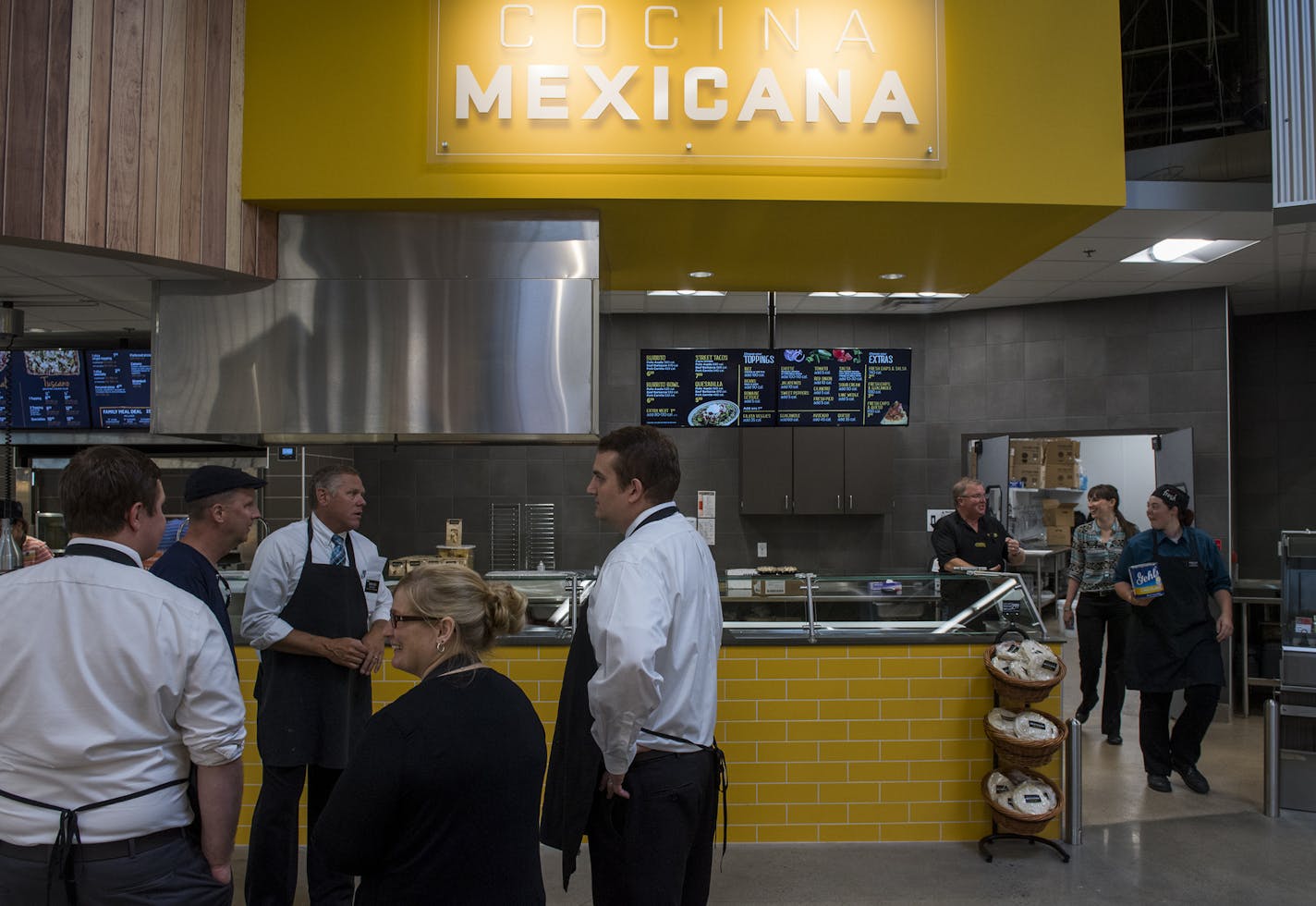 Workers stand in front of the new Mexican Cucina Grill. ] Isaac Hale &#xef; isaac.hale@startribune.com A new Hy-Vee supermarket is set to open at 16150 Pilot Knob Rd. in Lakeville, MN, tomorrow. The supermarket offers several new features and improvements such as a clothing department, Mexican Cucina Grill, sweets shop, and expanded grab-and-go meal options.