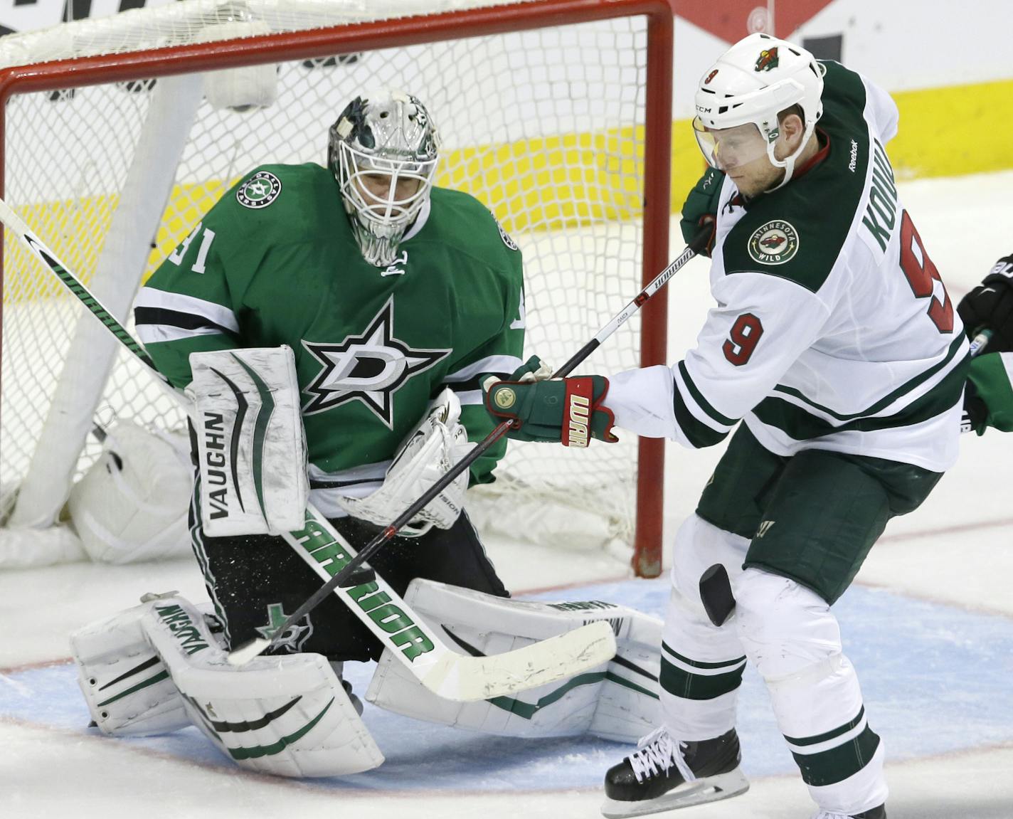 Minnesota Wild center Mikko Koivu (9) scores a goal against Dallas Stars goalie Antti Niemi (31) and defenseman Alex Goligoski (33) during overtime in Game 5 in the first round of the NHL Stanley Cup playoffs Friday, April 22, 2016, in Dallas. The Wild won 5-4. (AP Photo/LM Otero)