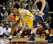 Gophers freshman forward Eric Curry was fouled by Michigan's Moritz Wagner (13) in the second half Sunday.