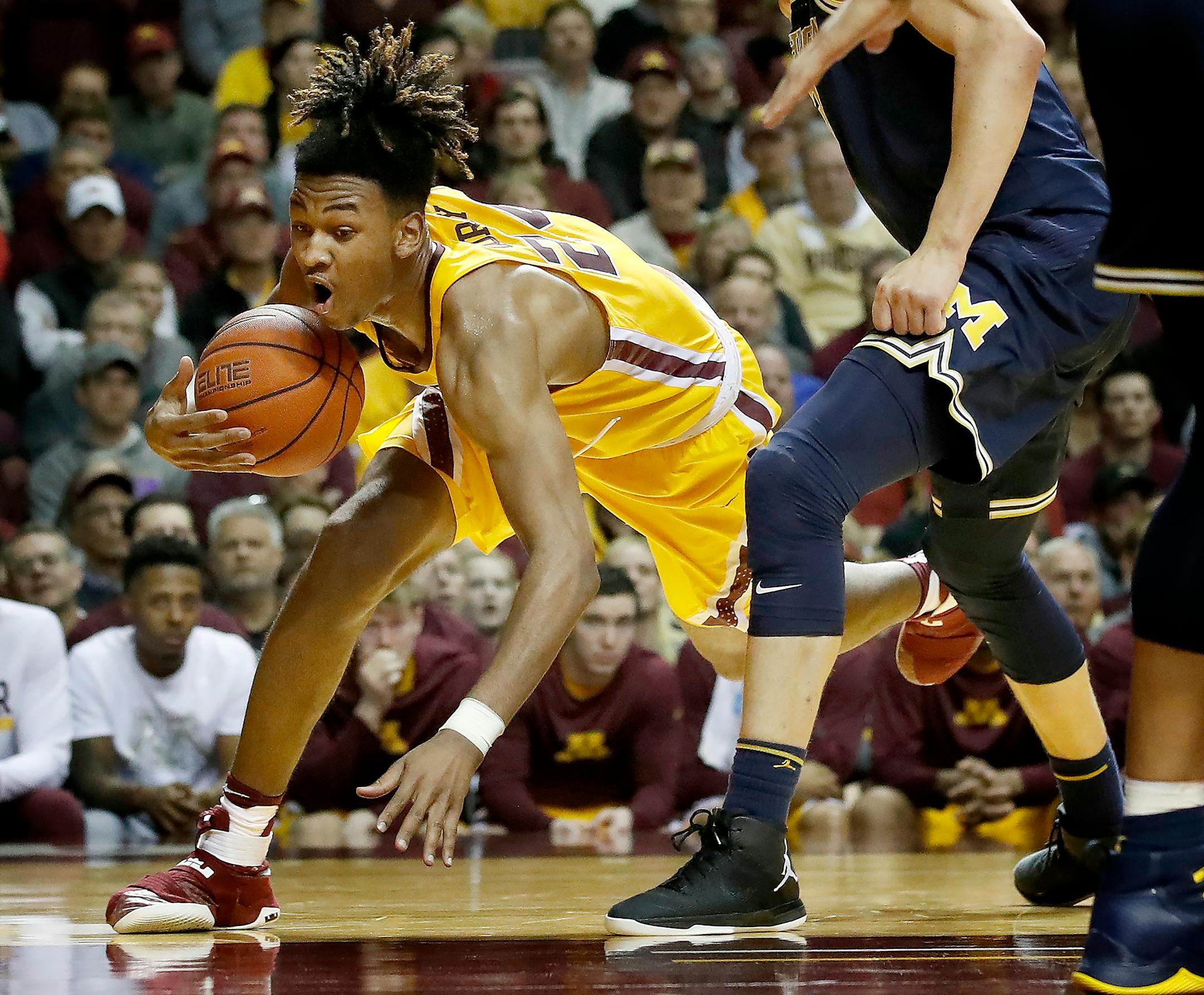 Gophers freshman forward Eric Curry was fouled by Michigan's Moritz Wagner (13) in the second half Sunday.