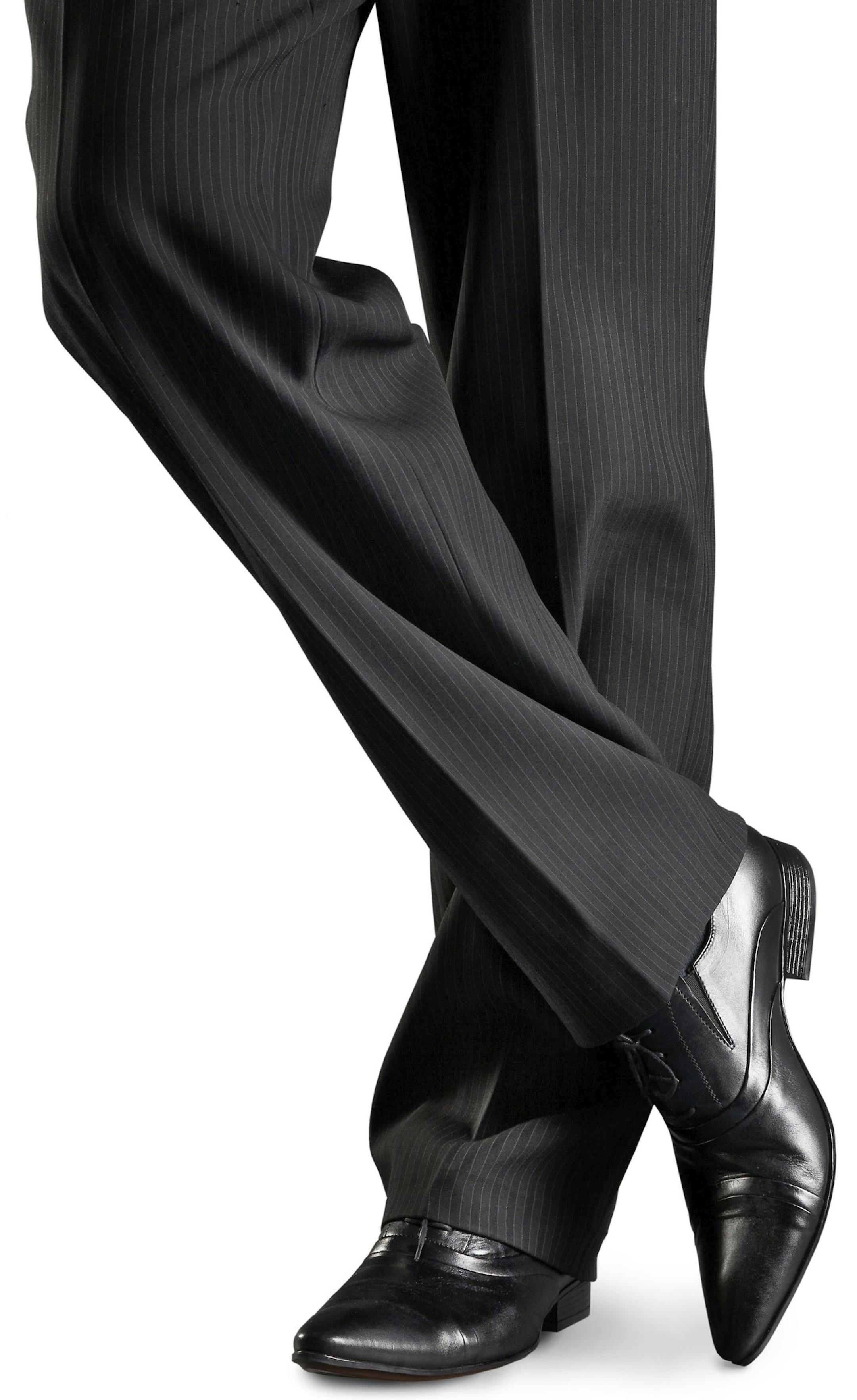 Man's feet in black trousers and black shoes