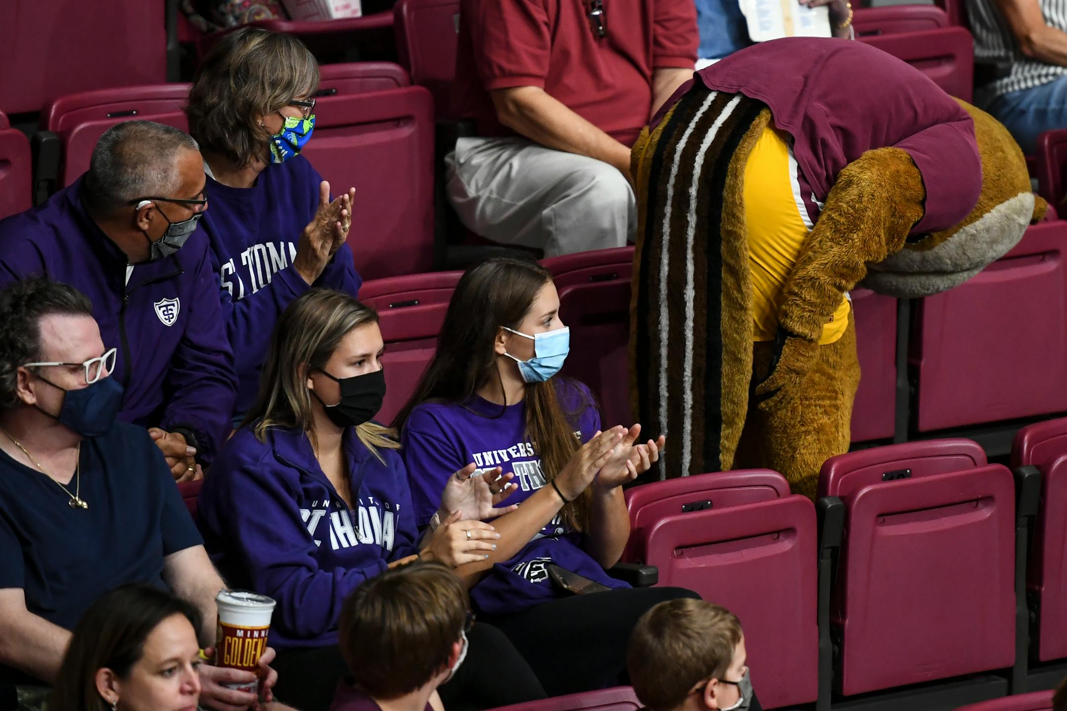 Goldy showed his backside to St. Thomas fans Eric and Debbie Monson, of Woodbury, and their daughters, Emma, left, and Kameron. 'It's never been done before, DIII to DI,' said Eric of St. Thomas.  'What a cool experience to play here at the pavilion!'
