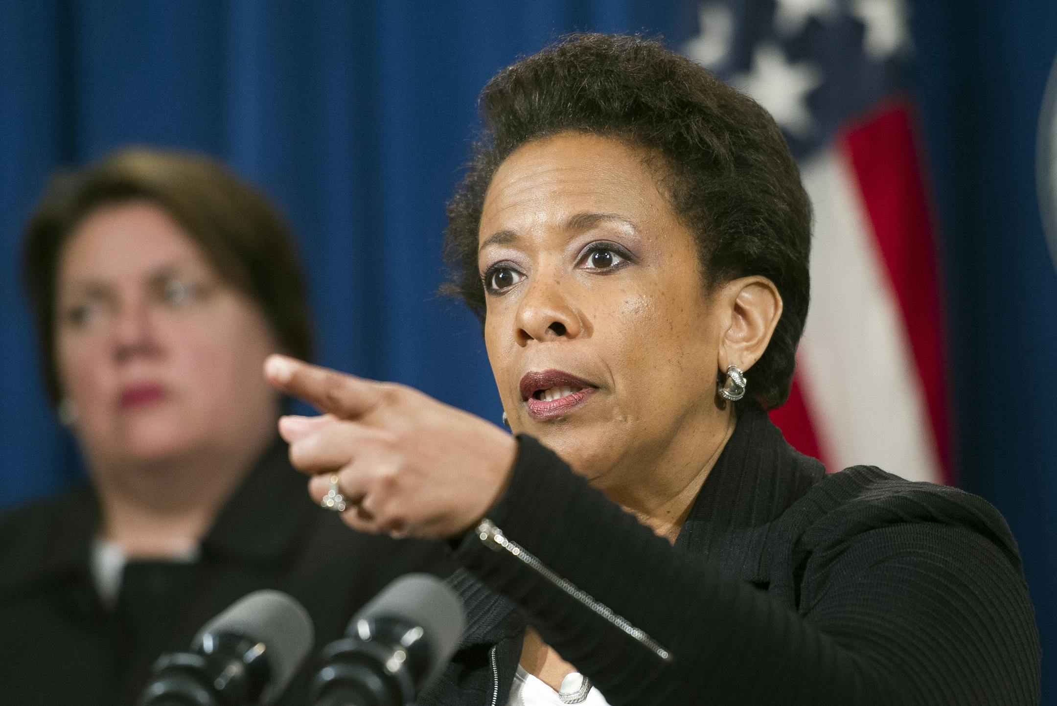 Attorney General Loretta Lynch gestures during a news conference at the Justice Department in Washington, Wednesday, May 20, 2015, to announce that four big banks will pay $2.5 billion in fines and plead guilty to criminally manipulating global currency market going back to 2007. (AP Photo/Cliff Owen)