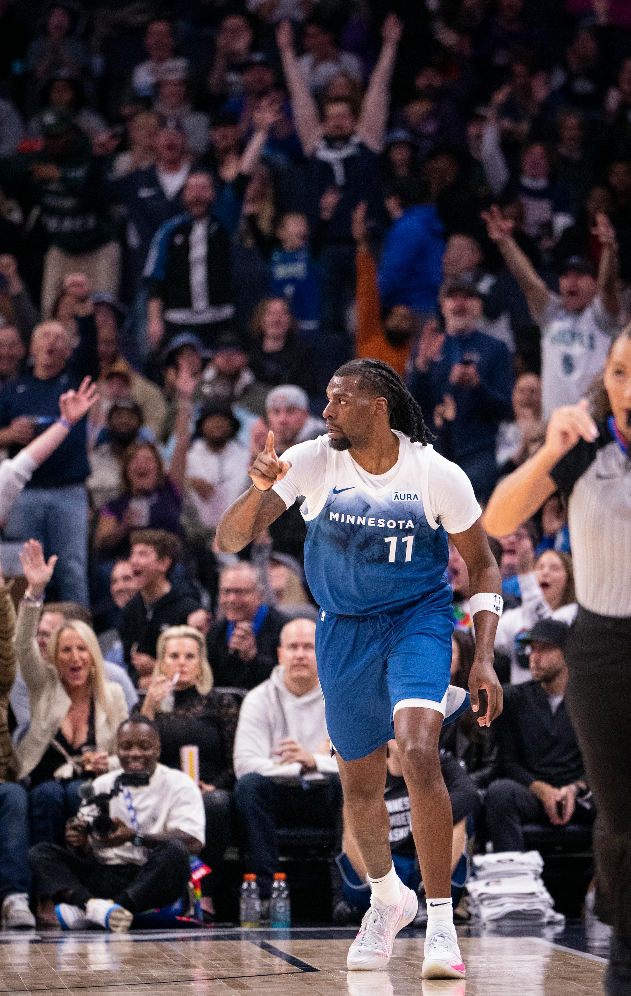Minnesota Timberwolves center Naz Reid (11) celebrates scoring during the first half of the game.