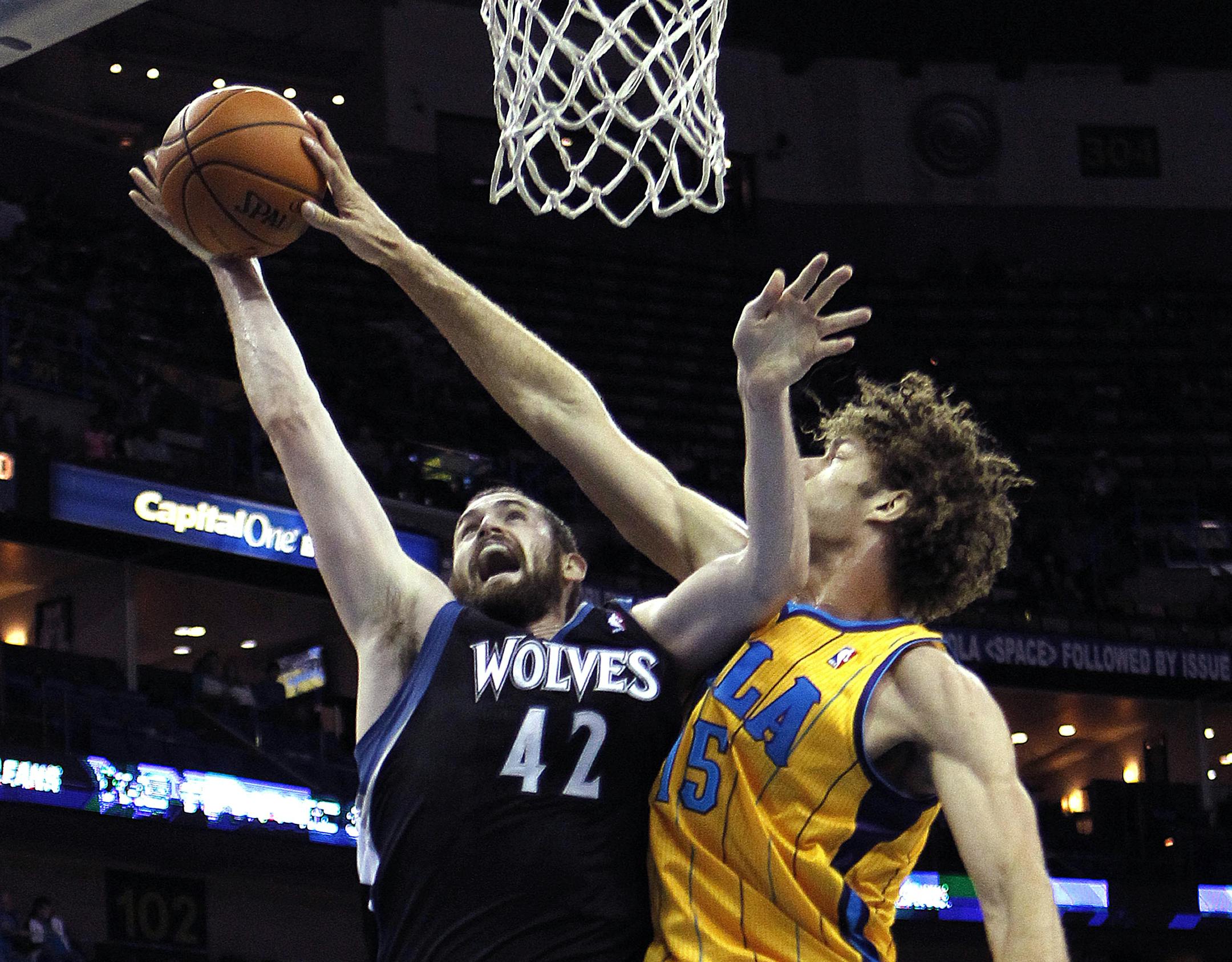 New Orleans Hornets center Robin Lopez (15) blocks a shot by Minnesota Timberwolves forward Kevin Love (42) in the first half of an NBA basketball game in New Orleans, Friday, Dec. 14, 2012. (AP Photo/Gerald Herbert)