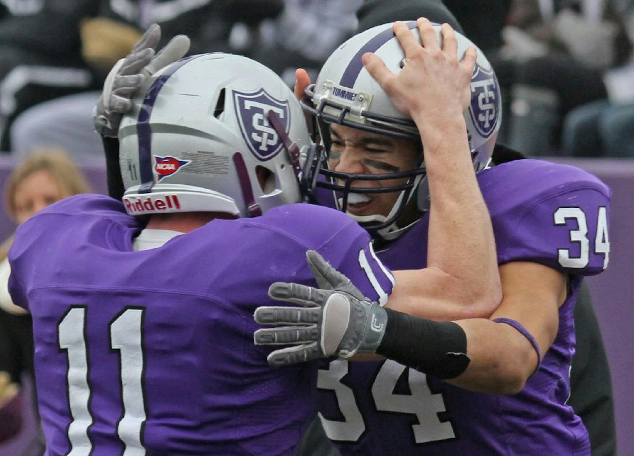 University of St. Thomas vs Hobart, Division 3 Football Quarterfinals, St. Thomas Stadium, 12/1/12. (left to right) Quarterback Matt O'Connell celebrated with St. Thomas runningback Brenton Braddock after Braddock scored the first Tommies touchdown against Hobart.
