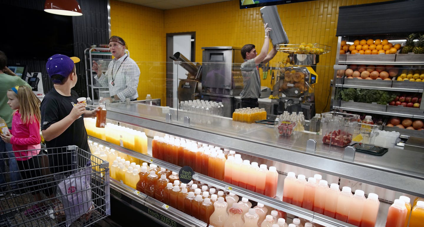 The new juice bar features a variety of fresh squeezed options including carrot, apple, and orange juice.]Chad Ferguson, president of Cub's retail west division and Anne Dament, sr vp of retail, merchandise and marketing, will give Ewoldt a tour of the new store. Richard Tsong-Taatarii/Richard.tsong-taatarii@startribune.com