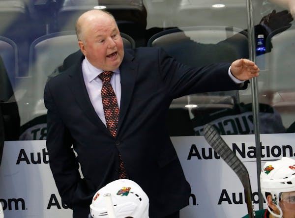 FILE - In this Oct. 4, 2016, file photo, Minnesota Wild head coach Bruce Boudreau directs his players in the second period of an NHL preseason hockey 