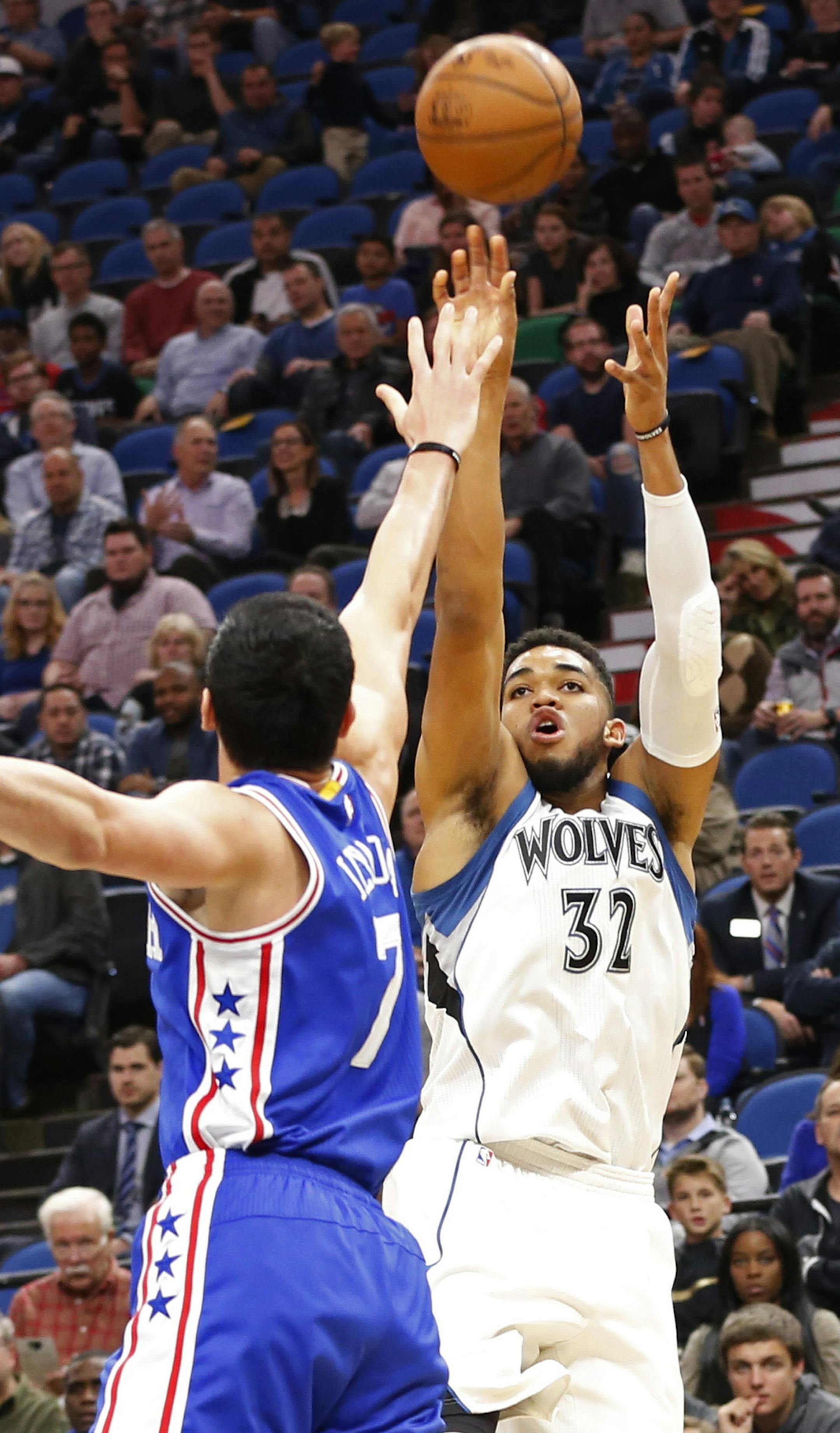 Minnesota Timberwolves' Karl-Anthony Towns, right, shoots over Philadelphia 76ers' Ersan Ilyasova of Turkey in the first quarter of an NBA basketball game Thursday, Nov. 17, 2016, in Minneapolis. (AP Photo/Jim Mone)